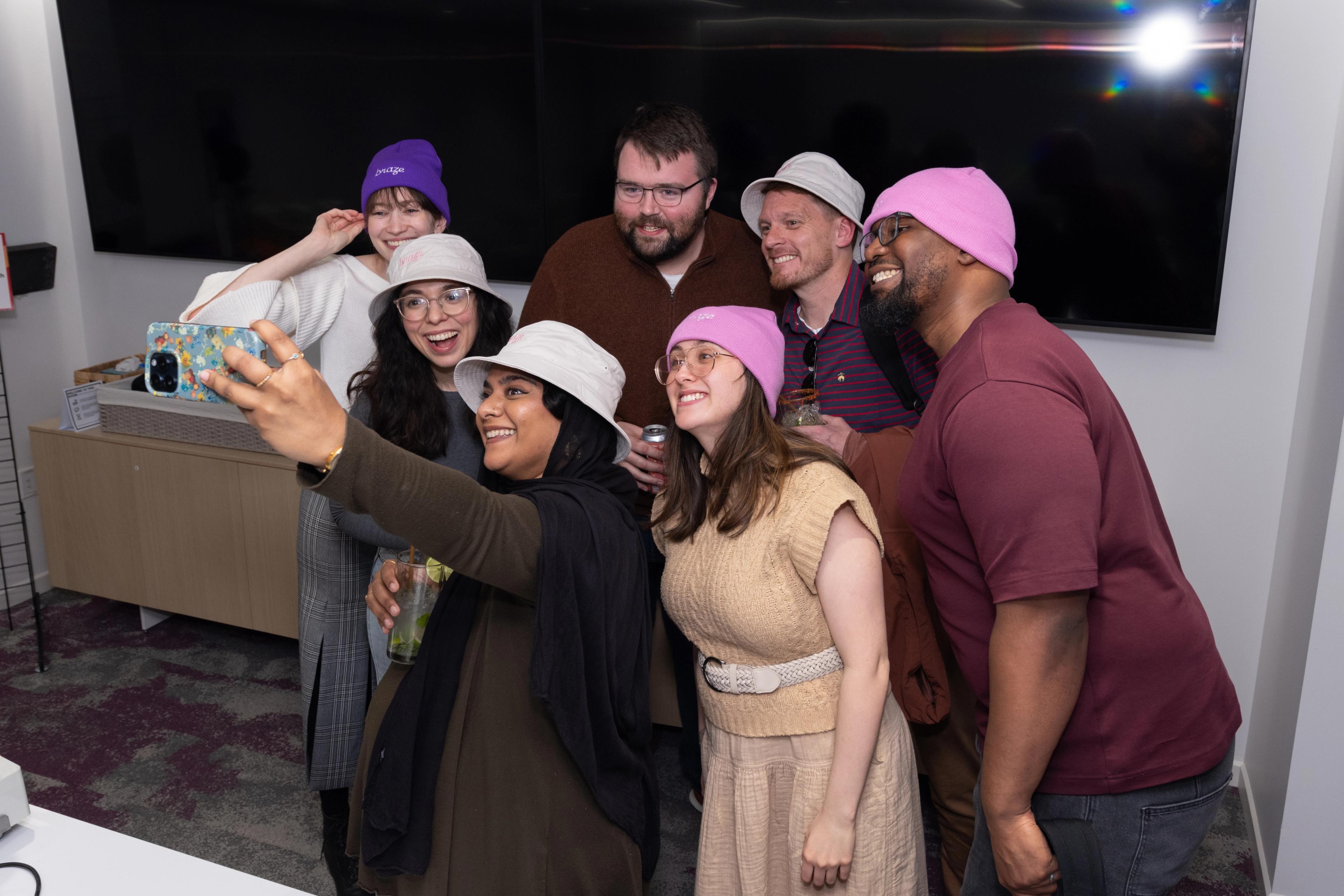 a group of people are taking a selfie together in a room 