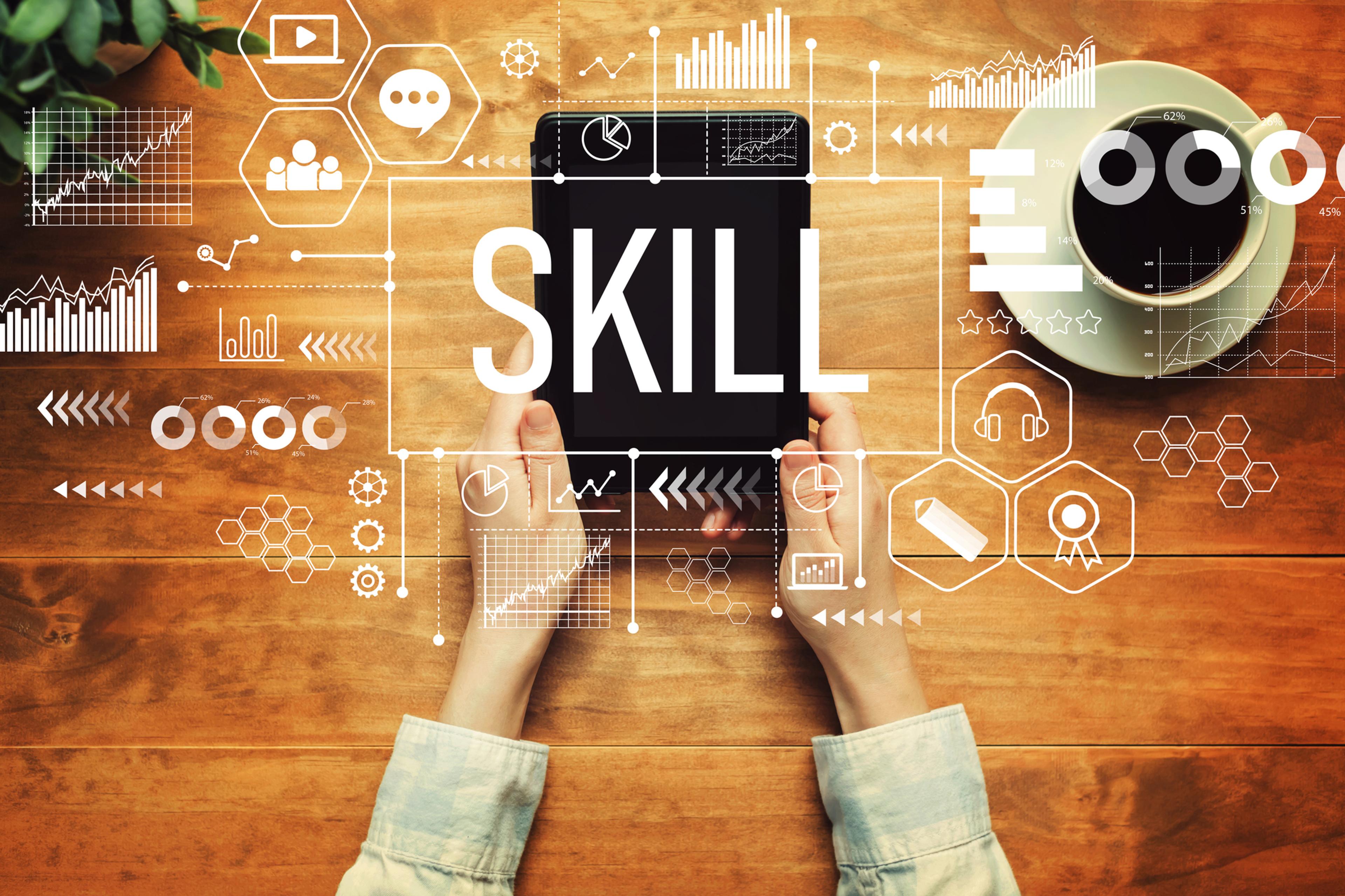 a person is holding a tablet with the word skill written on it .