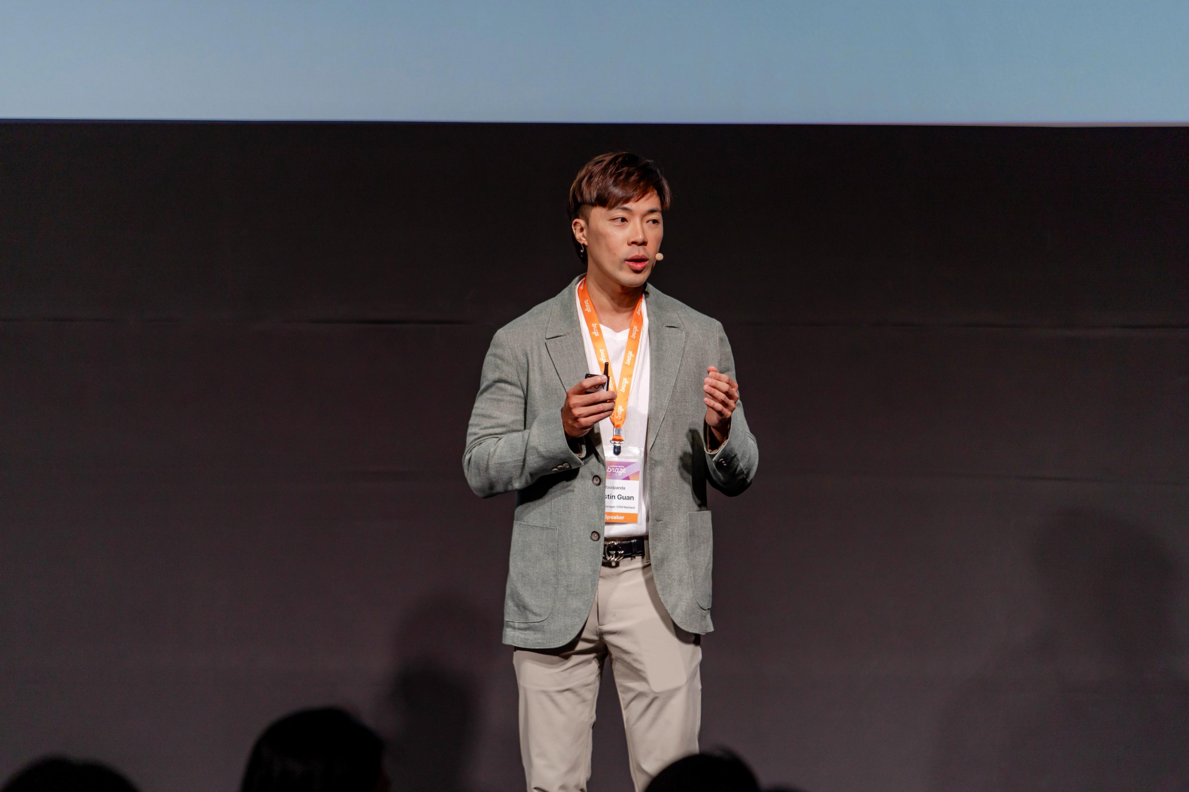 a man in a suit is standing on a stage giving a presentation .