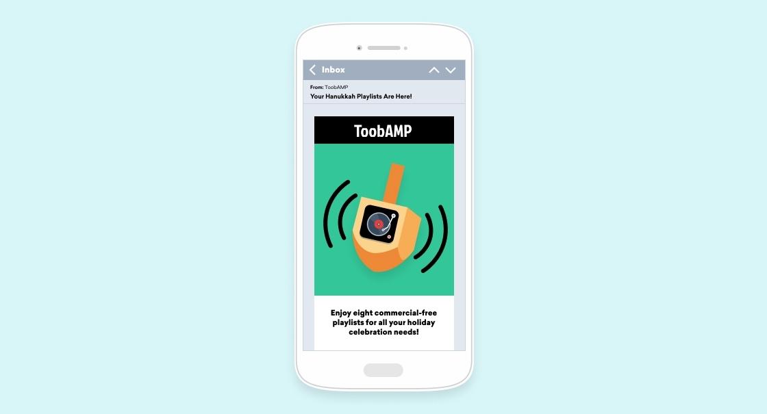 A smartphone displays an email promoting ToobAMP, featuring a graphic of a musical note and a holiday-themed message about commercial-free playlists.