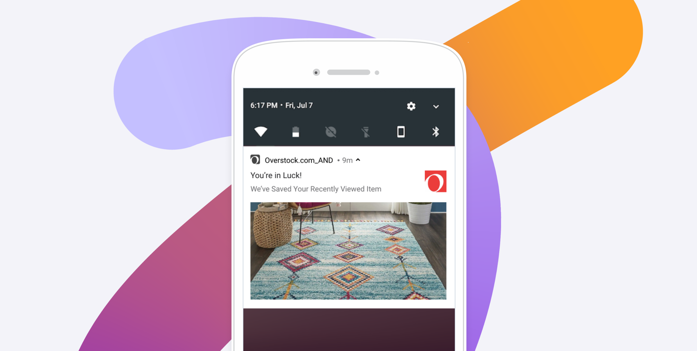 Smartphone displaying an Overstock notification that a recently viewed colorful area rug has been saved.