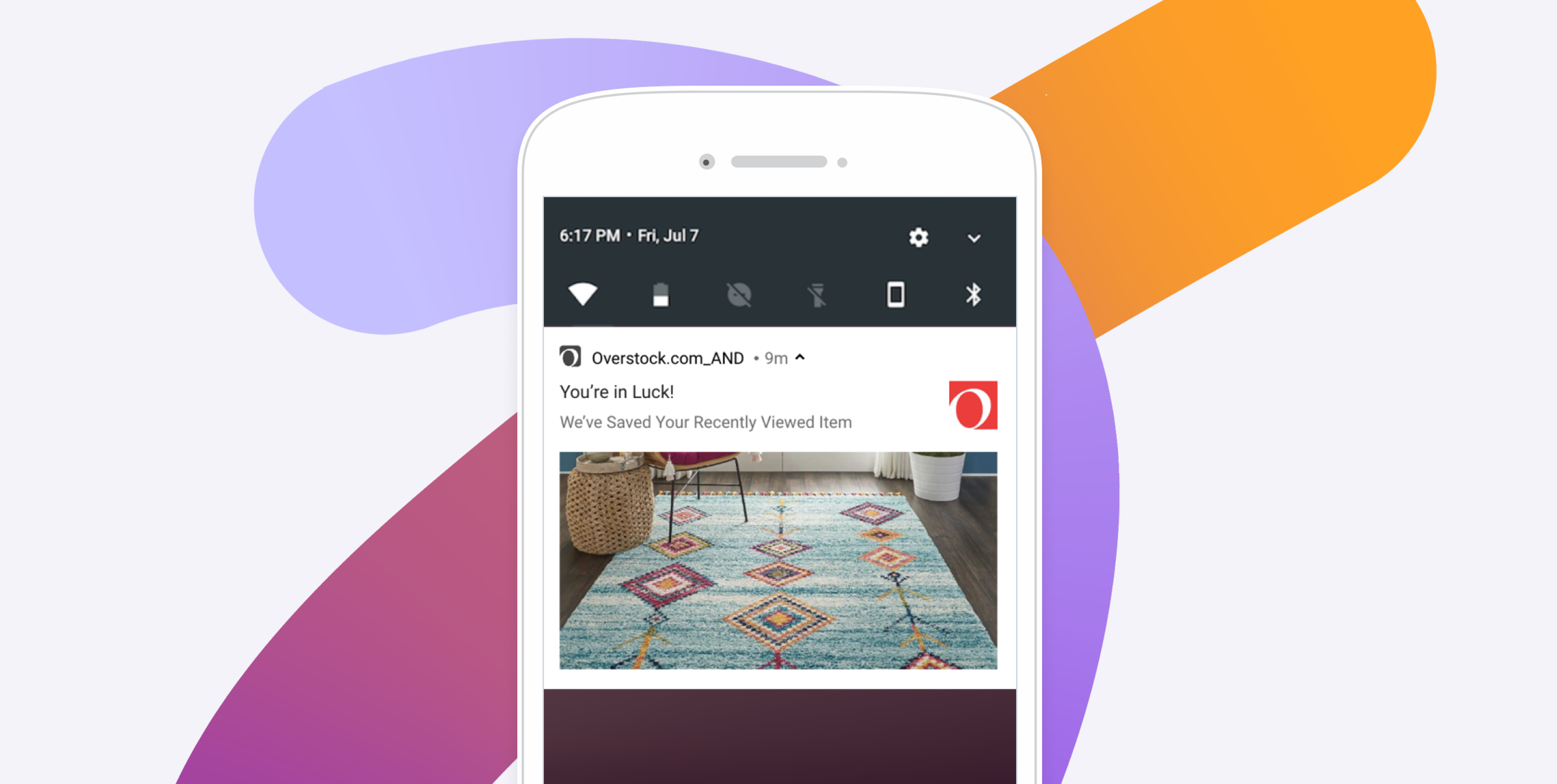 Smartphone displaying an Overstock notification that a recently viewed colorful area rug has been saved.