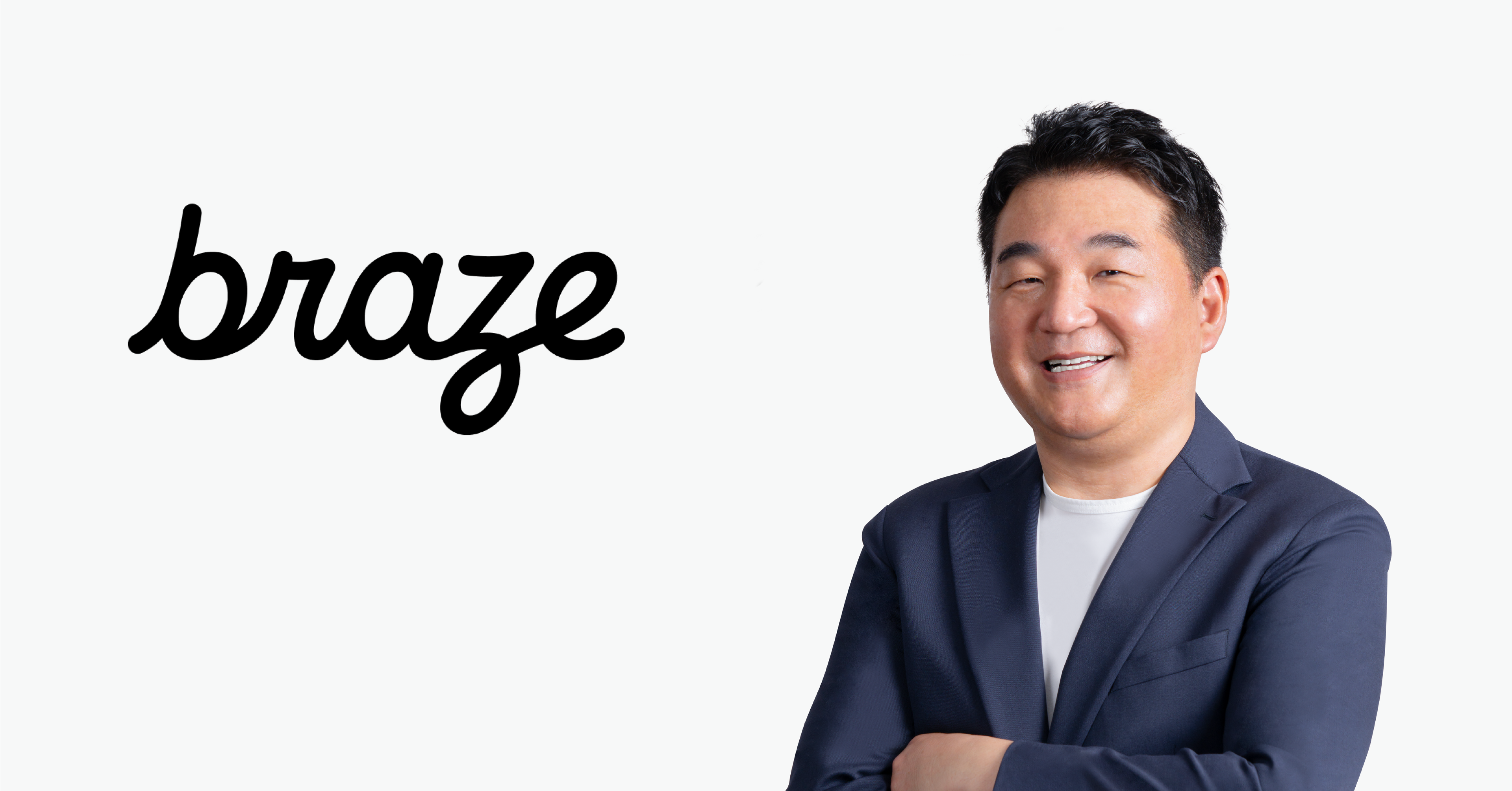 a man stands in front of a braze logo