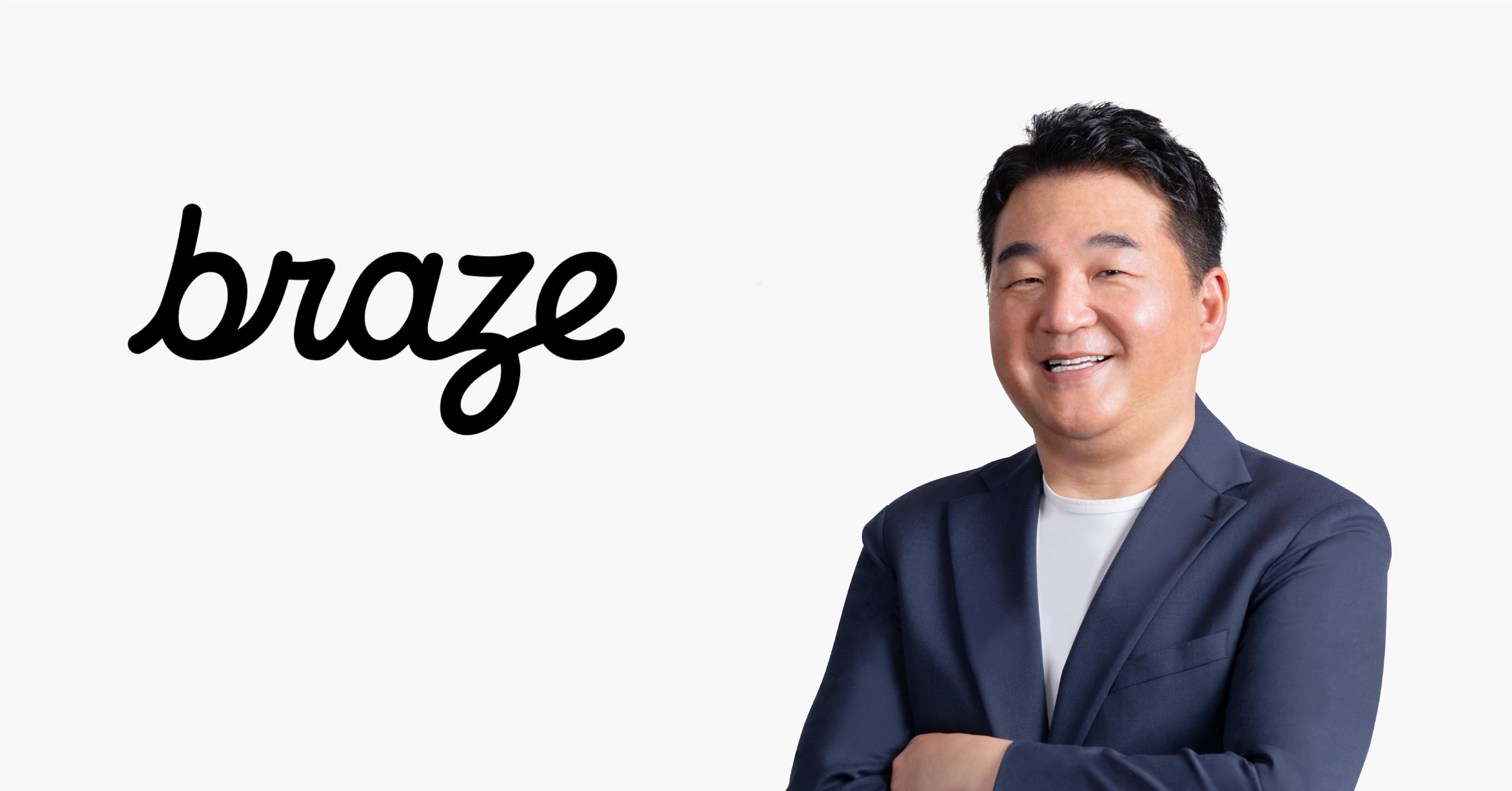 a man stands in front of a braze logo