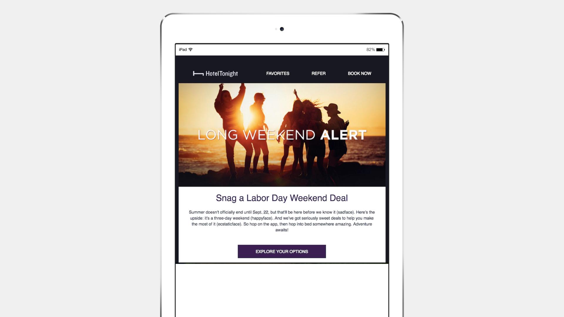 A tablet displaying a promotional email for Labor Day weekend deals, featuring a silhouette of people celebrating against a sunset background. The text highlights a "Long Weekend Alert" and encourages users to explore options.