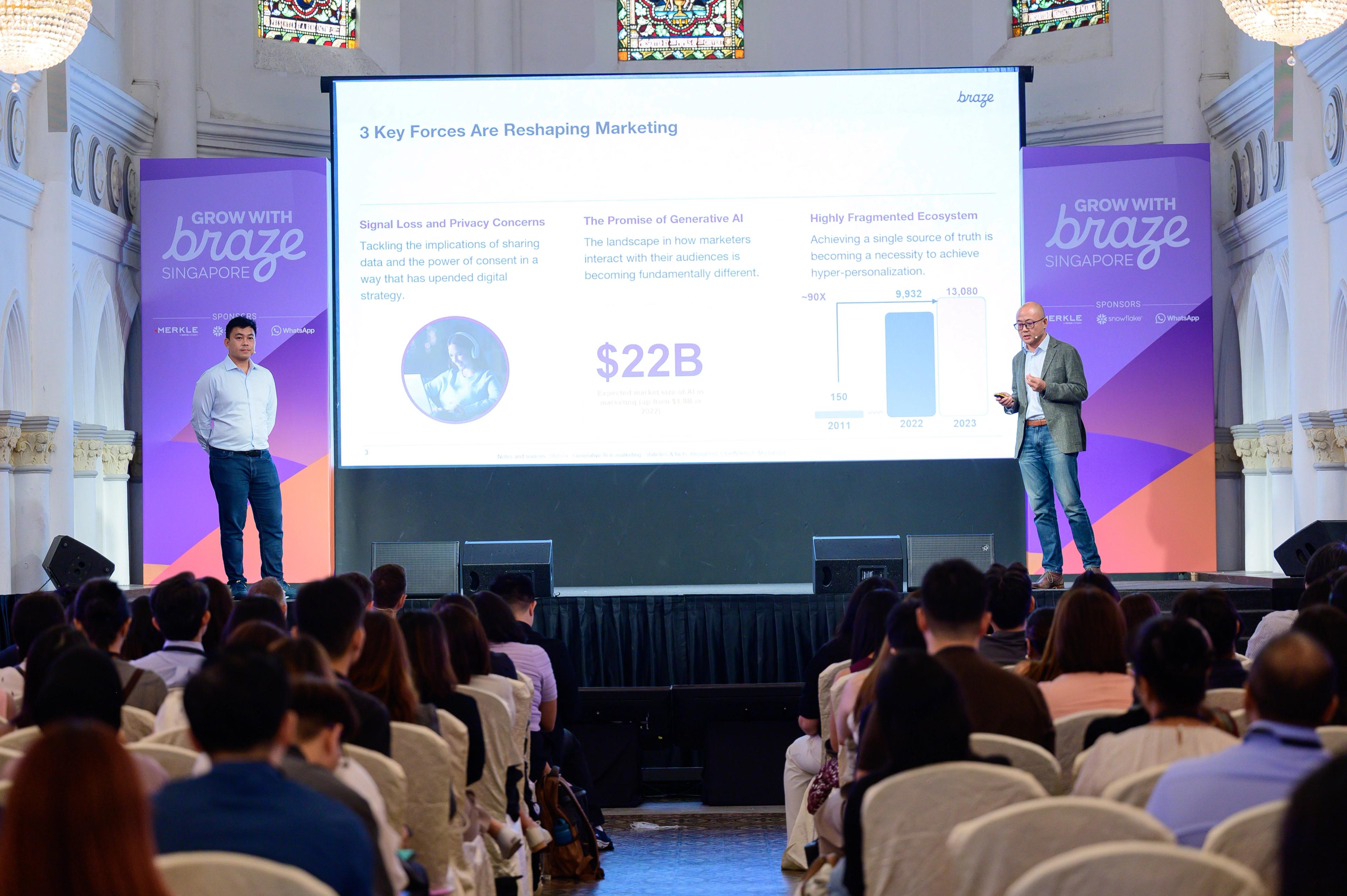 a man is giving a presentation in front of a crowd of people .
