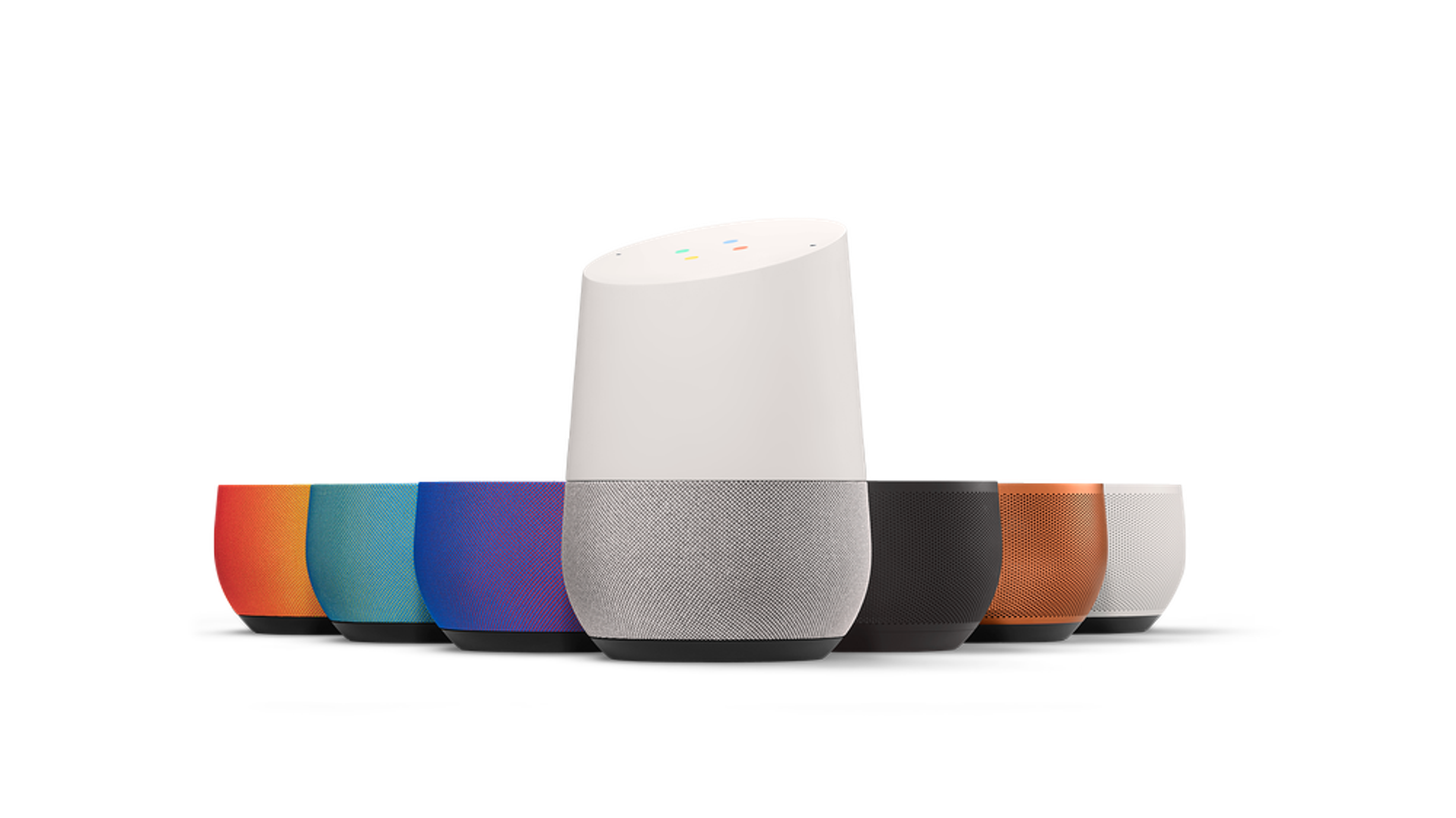 A collection of smart speakers in various colors, with one taller white speaker in the center and shorter colored speakers arranged around it.