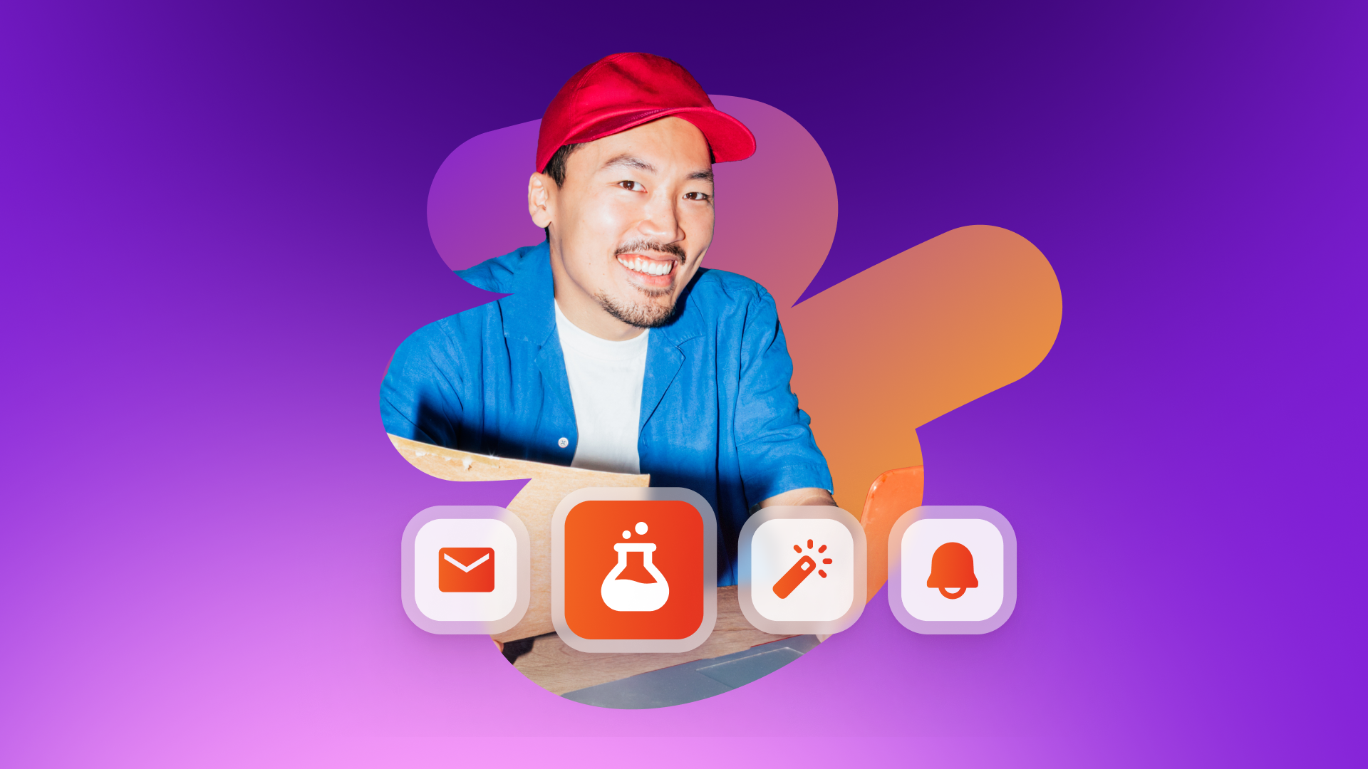Smiling man in a red cap and blue shirt looks out from a box, with icons for mail, a beaker, a magic wand, and a bell in front, on a purple and orange background.