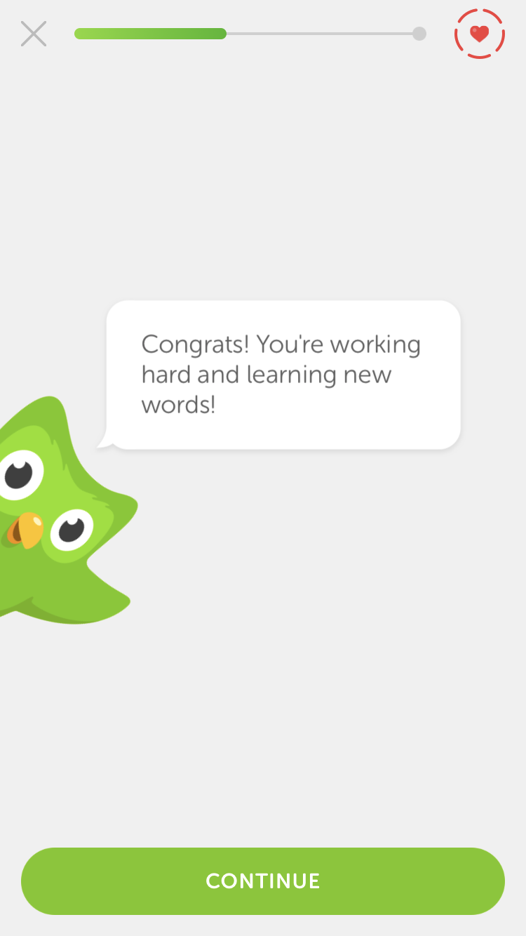 A green cartoon owl with big eyes peeks from the left, displaying a speech bubble that says, "Congrats! You're working hard and learning new words!" A "Continue" button is at the bottom.