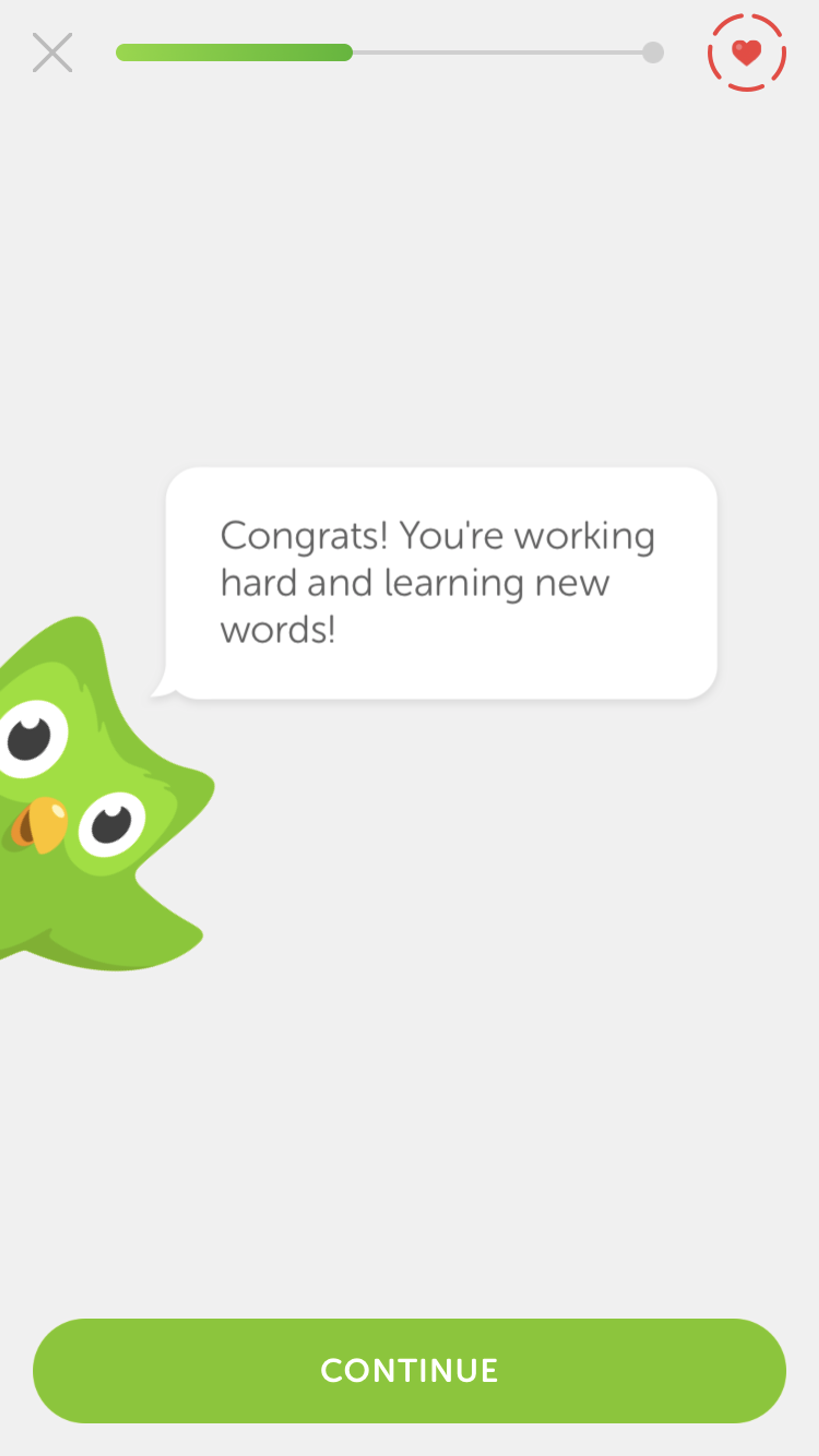 A green cartoon owl with big eyes peeks from the left, displaying a speech bubble that says, "Congrats! You're working hard and learning new words!" A "Continue" button is at the bottom.