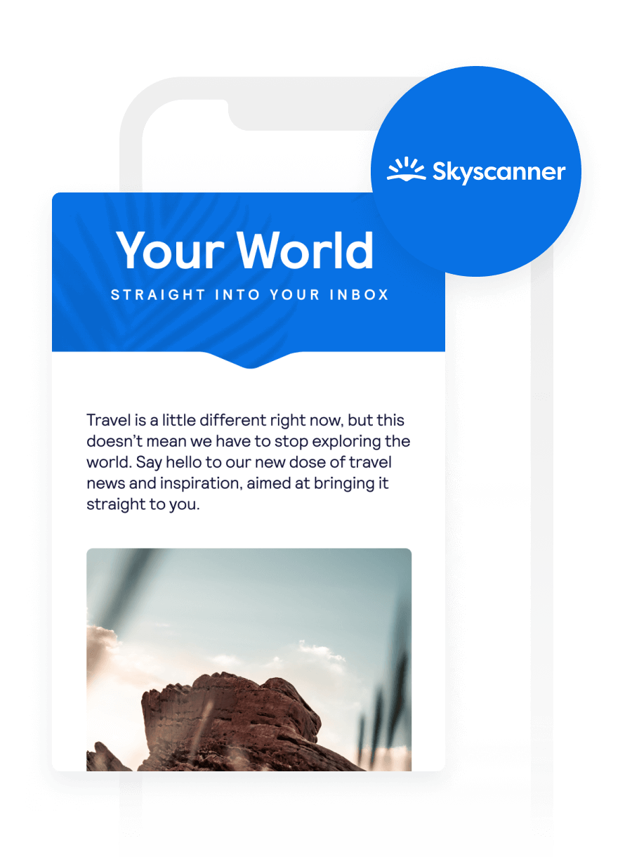 A mobile phone displays a Skyscanner email with the headline "Your World" and a desert landscape photo.