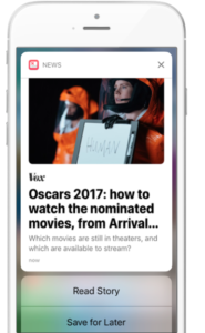 A smartphone screen displaying a news notification about the 2017 Oscars, featuring an article from Vox. The notification includes options to read the story or save it for later.