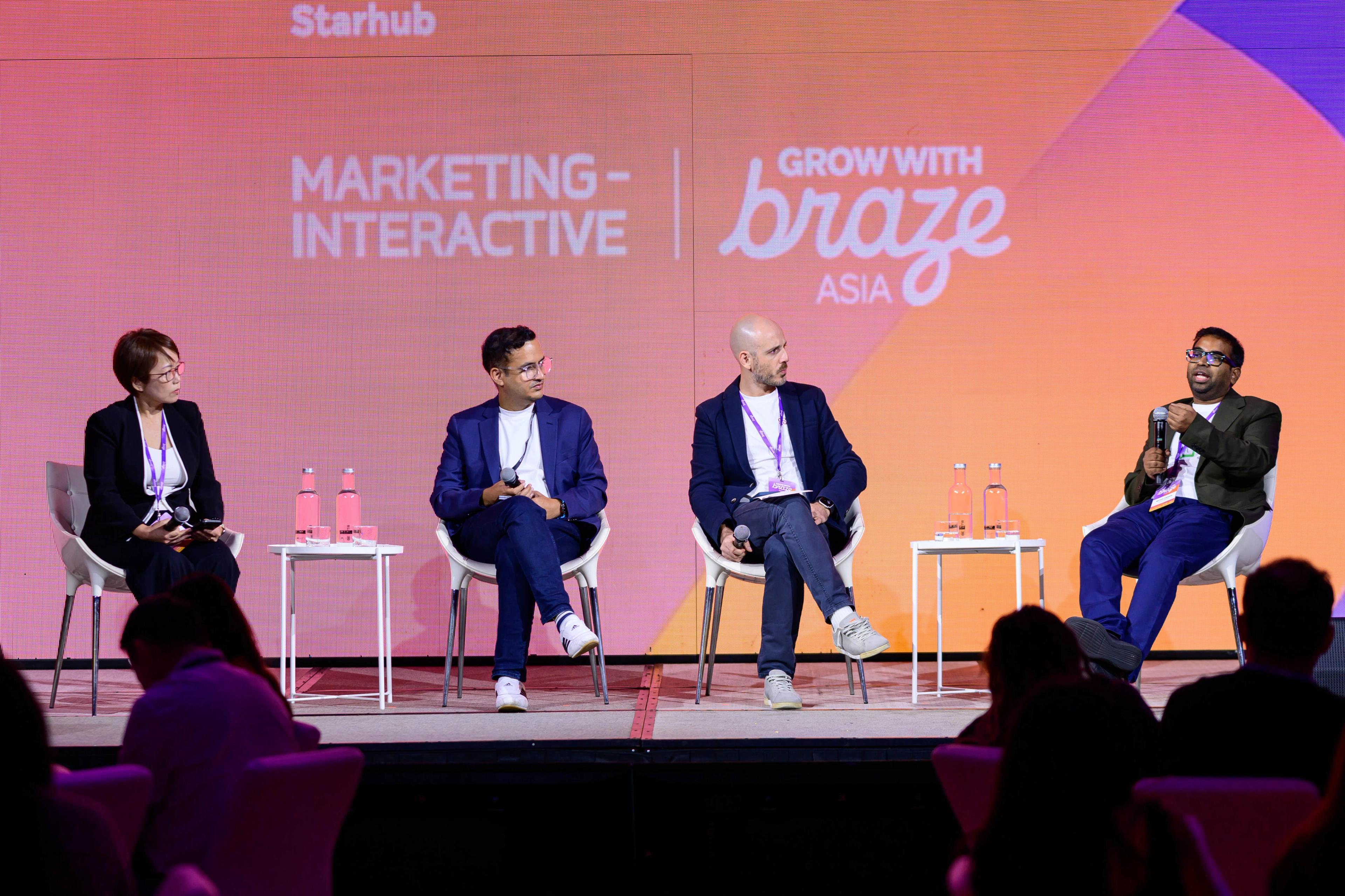 A panel of speakers on stage