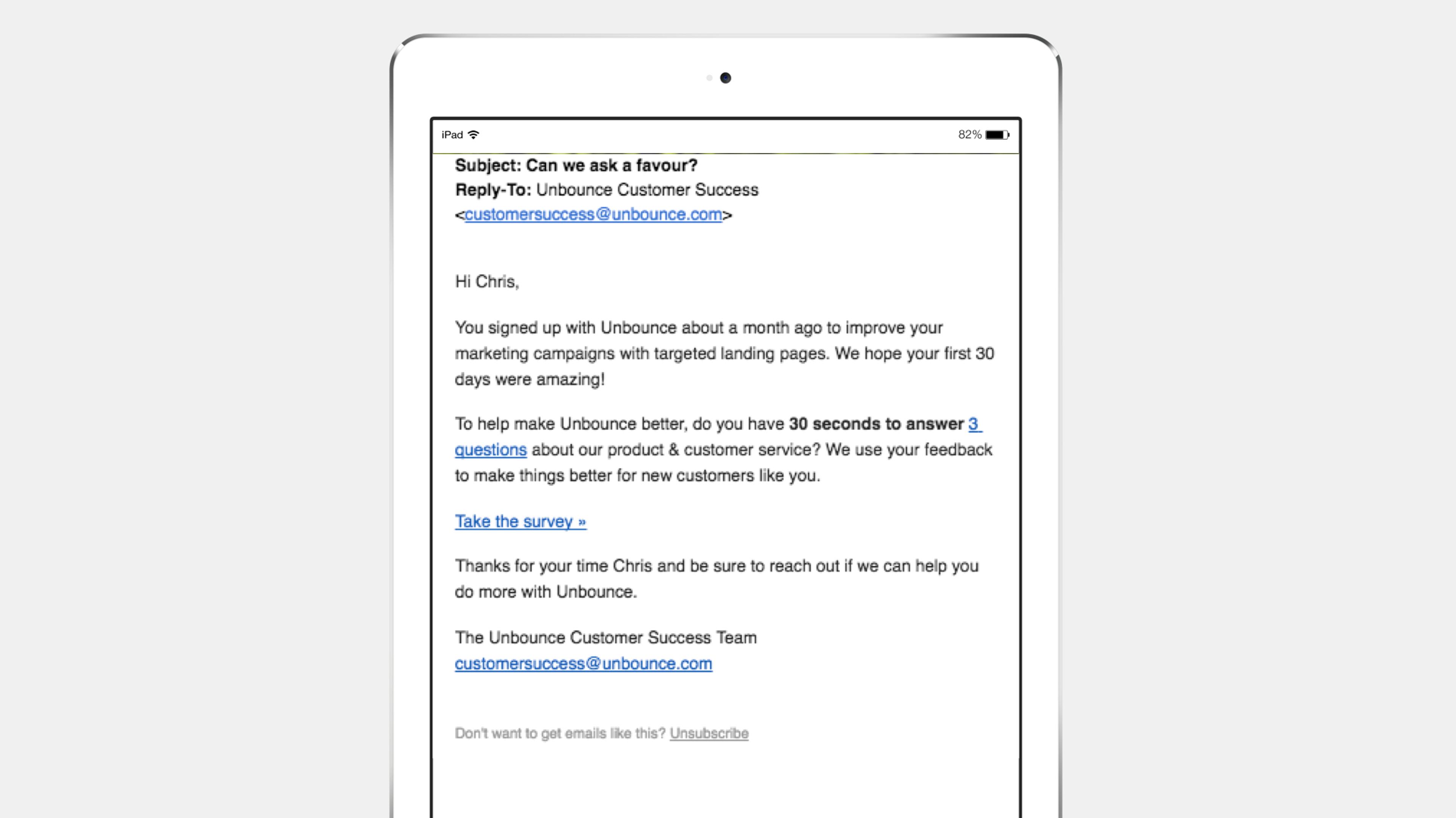 An email on an iPad screen from Unbounce Customer Success, asking for feedback on marketing campaigns and offering a survey link. The subject line reads, "Can we ask a favor?