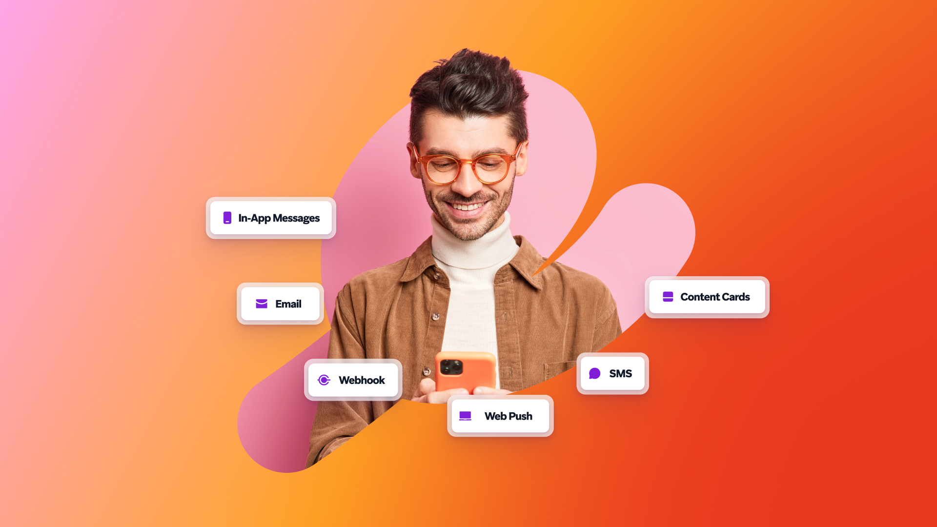 a man wearing glasses is smiling while looking at his phone
