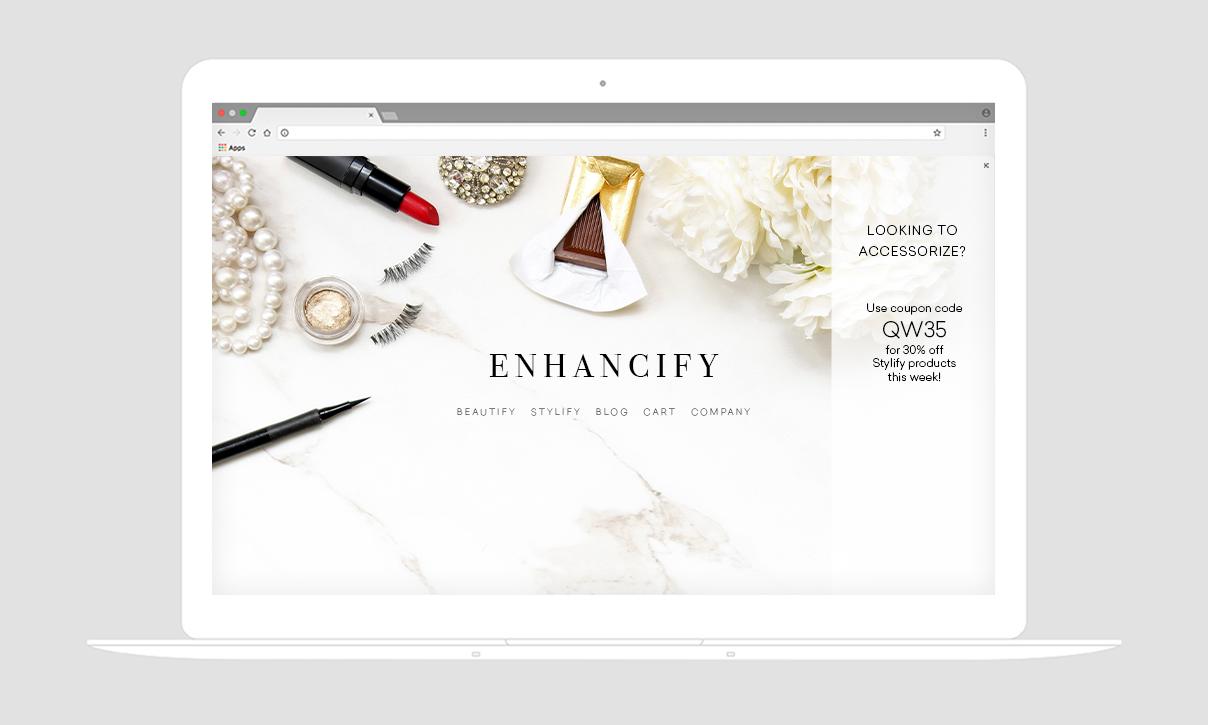 A laptop displaying a website called "Enhancify" with beauty products, including lipstick, false eyelashes, and flowers. The site promotes a coupon code for discounts on styling products.