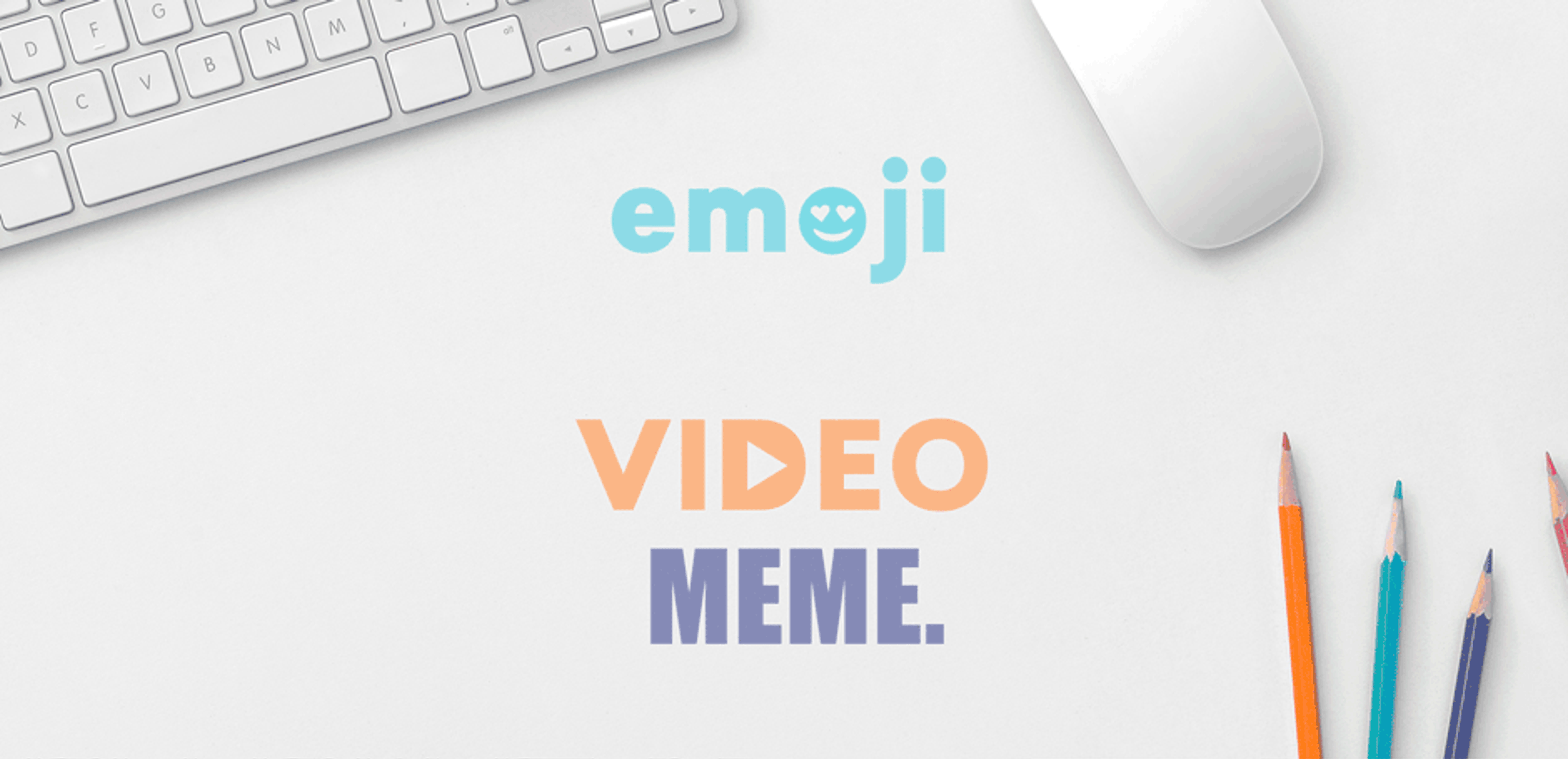 emoji video meme is written on a white surface next to a keyboard and mouse representing gif vs meme