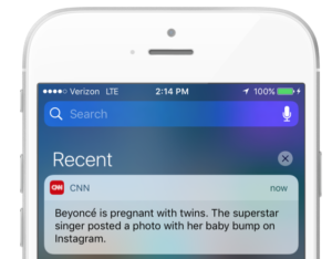 A smartphone screen displaying a notification from CNN about Beyoncé being pregnant with twins. The notification includes details about her posting a photo on Instagram.