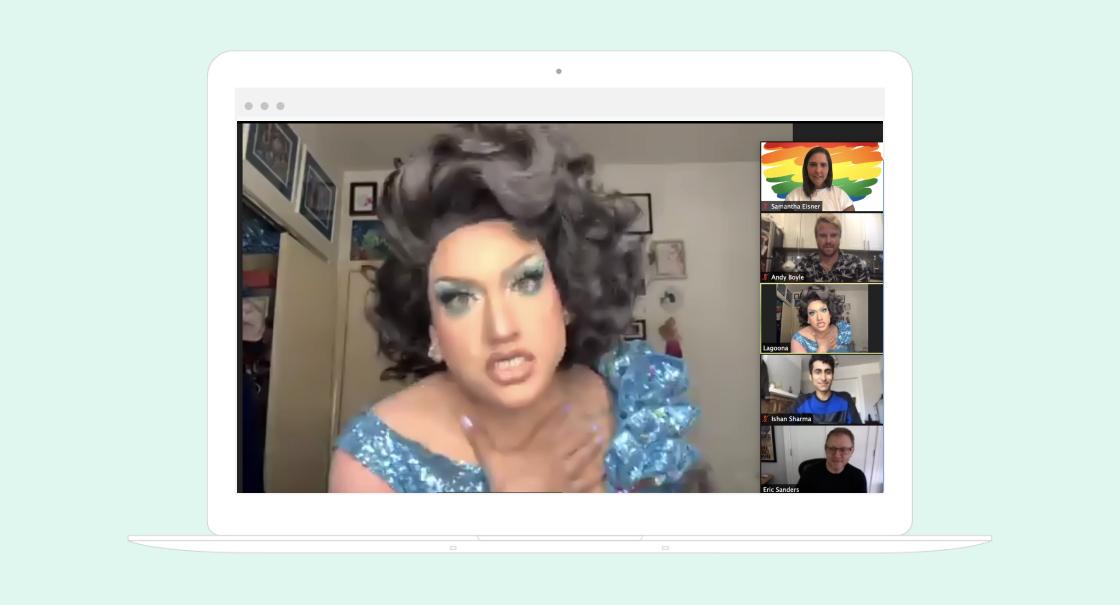 A drag performer in a blue outfit gestures passionately during a virtual meeting, with several participants visible in smaller video frames. The background features colorful decorations and artwork.