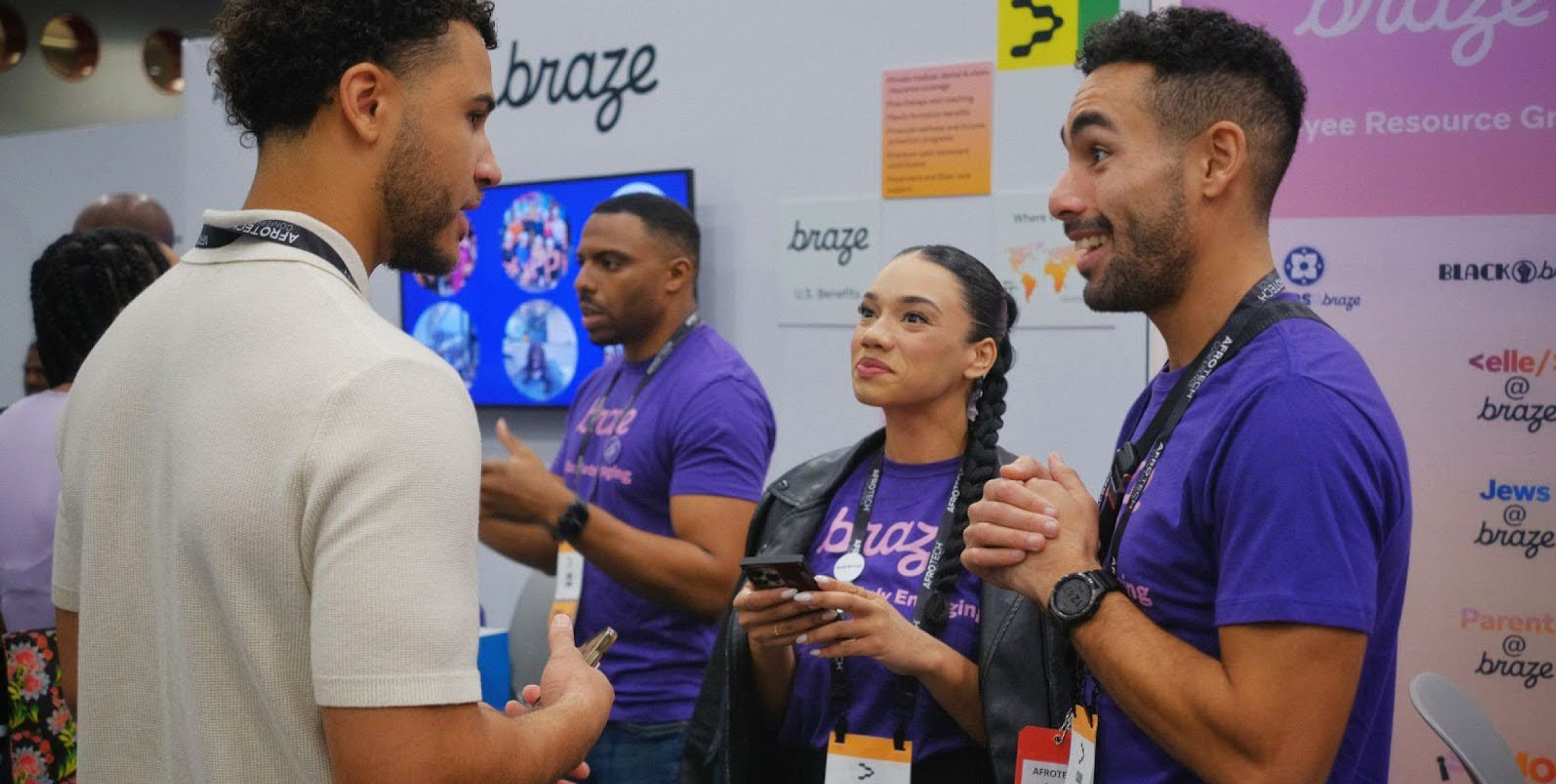 a group of people standing in front of a sign that says braze