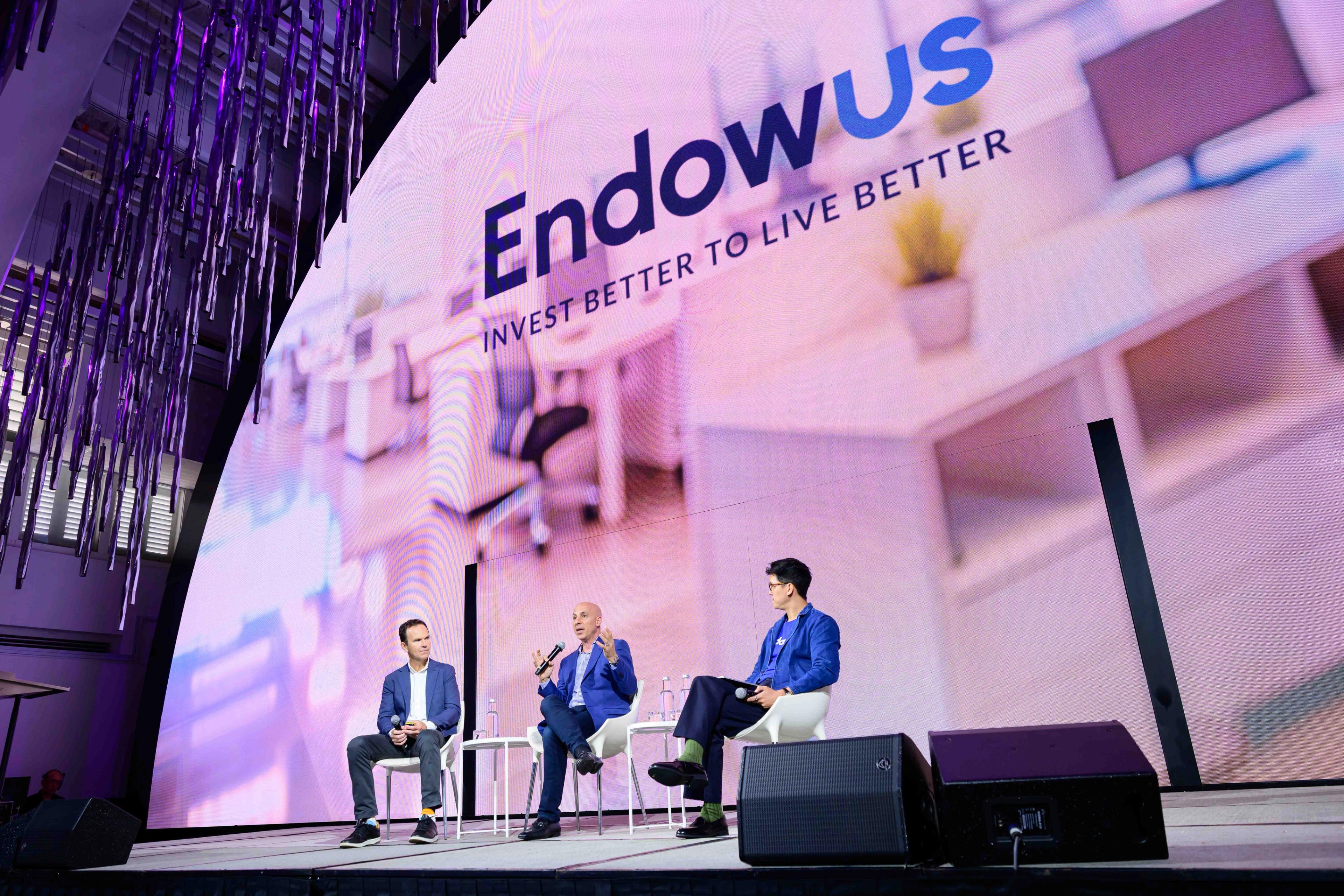 A panel of event speakers on stage