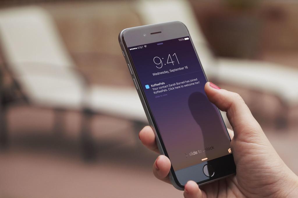 A person holding a smartphone displaying a notification at 9:41 AM on September 16. The screen shows a message from a contact.