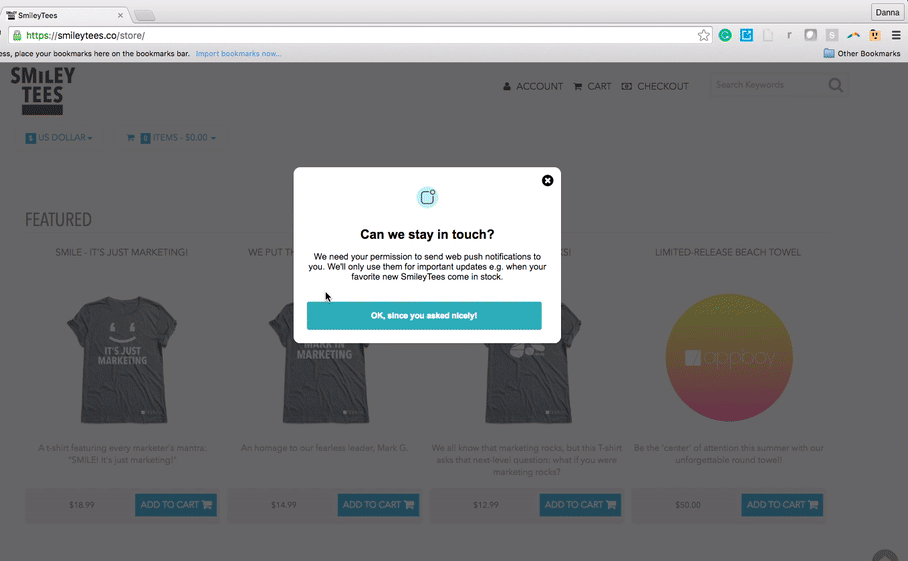 A pop-up message on a website asking for permission to send push notifications about favorite items in stock. The background shows a featured products section with t-shirts.