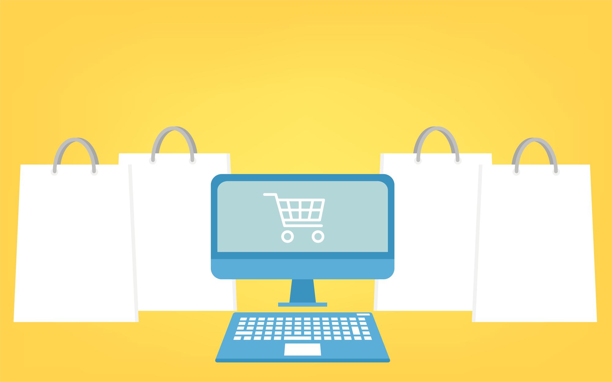 a computer with a shopping cart on the screen is surrounded by shopping bags .