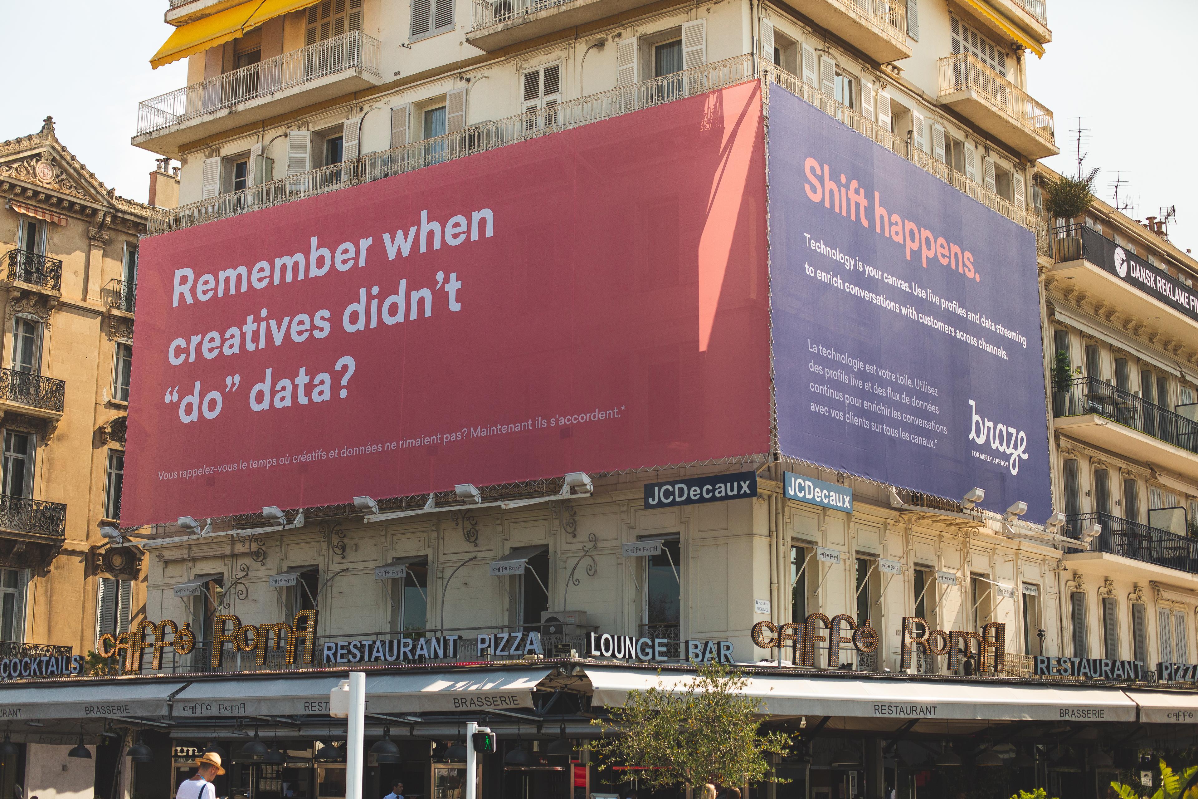 A large billboard on a building features the text "Remember when creatives didn't 'do' data?" and "Shift happens." The advertisement promotes a company called Bonze.