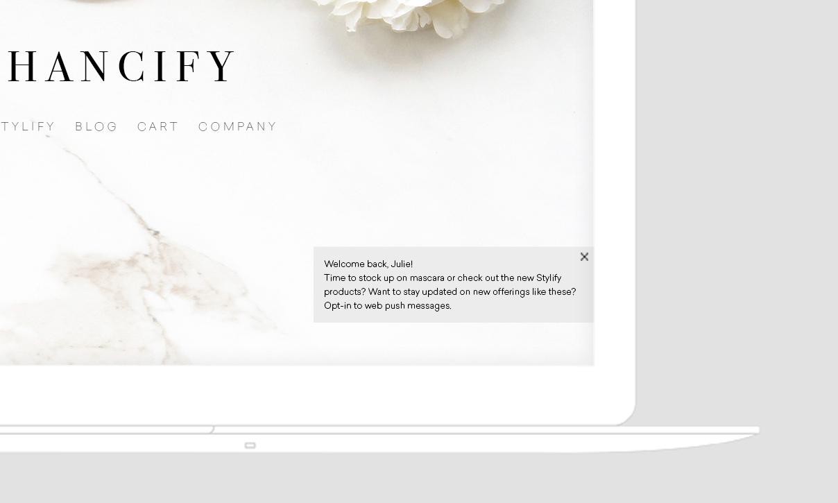 A welcome message on a website, addressing a user named Julie and prompting her to opt-in for web push messages about new products. The background features a marble texture with a floral element.