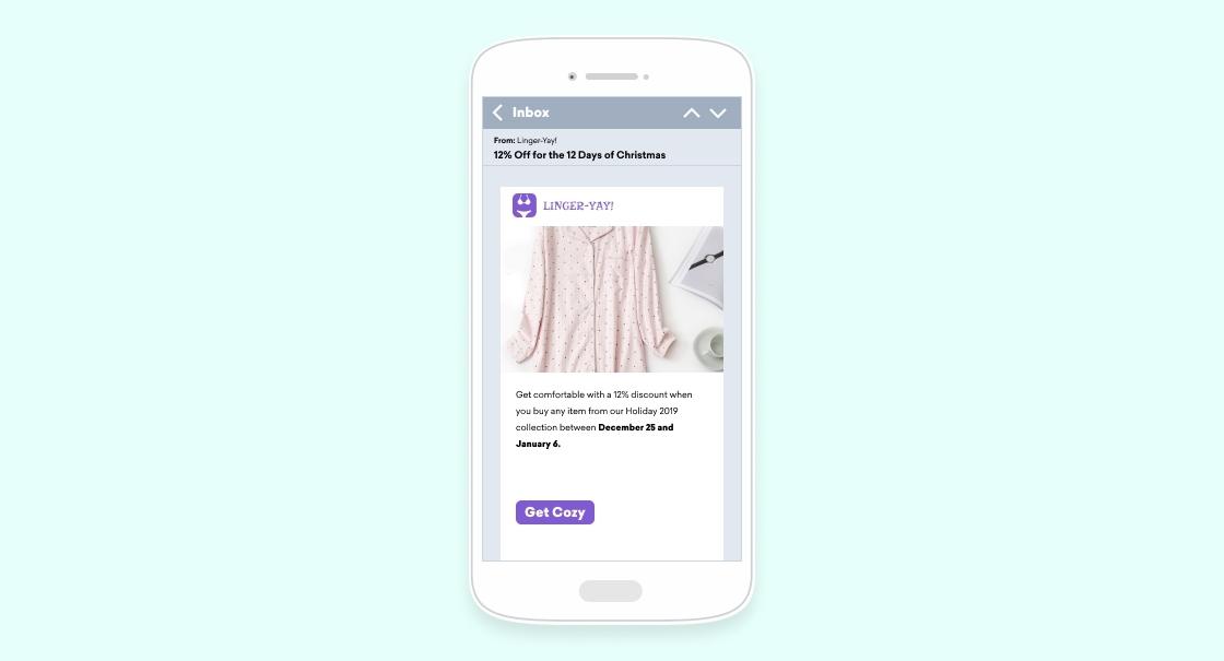 A mobile phone screen displaying an email about a 10% discount on holiday loungewear, with a pink patterned garment featured. The promotion runs from December 2nd to January 1st.