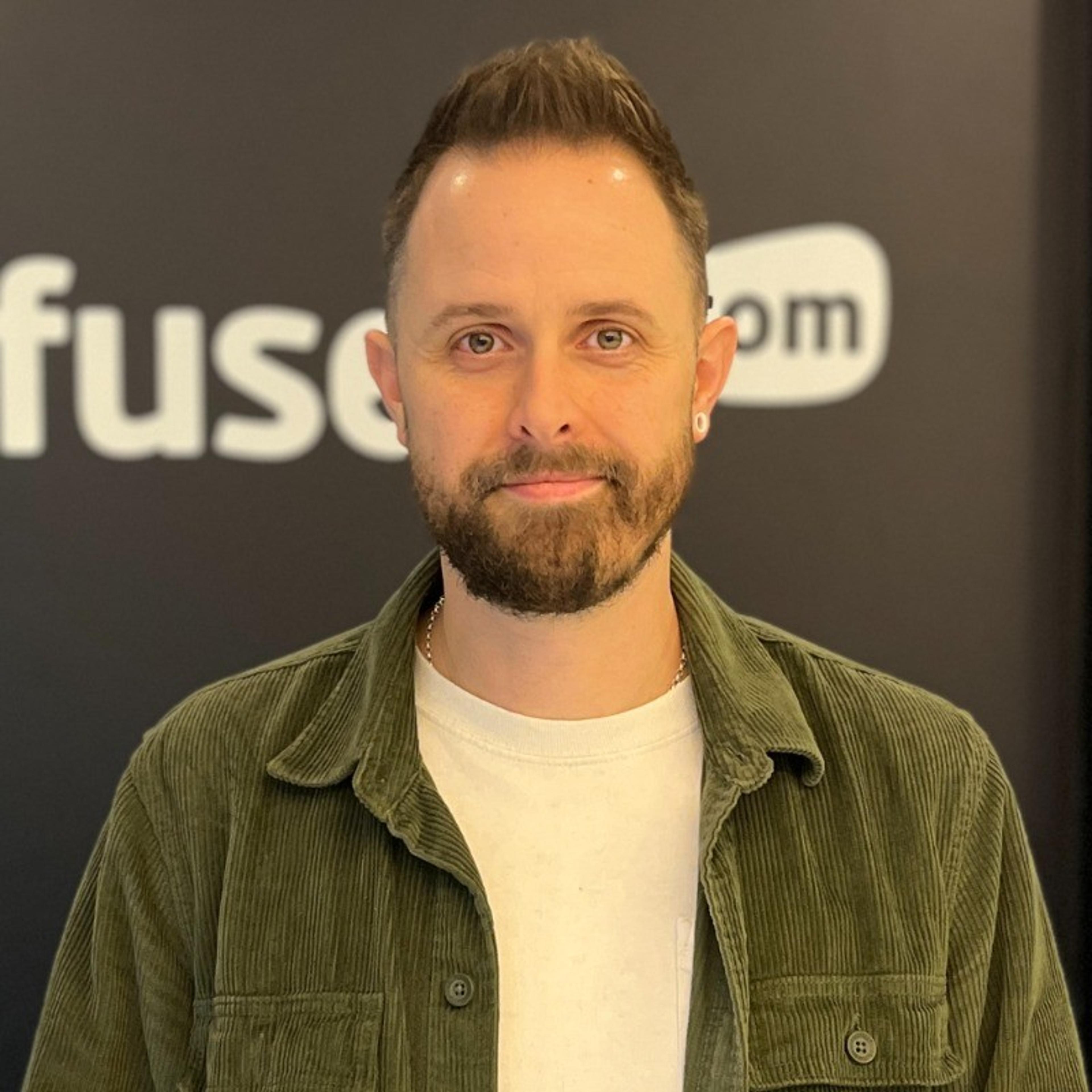 Headshot of a bearded man wearing a green corduroy shirt over a white T-shirt.