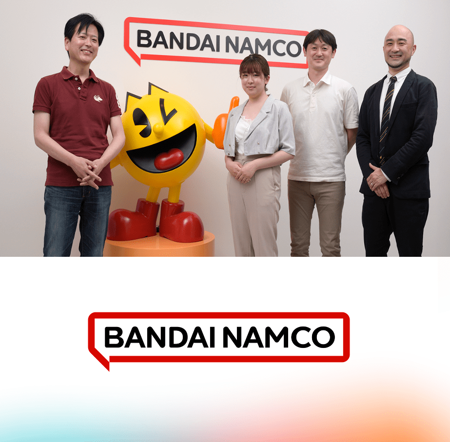 バンダイナムコの社員が四人写っていて間にはオリジナルキャラクターがいる