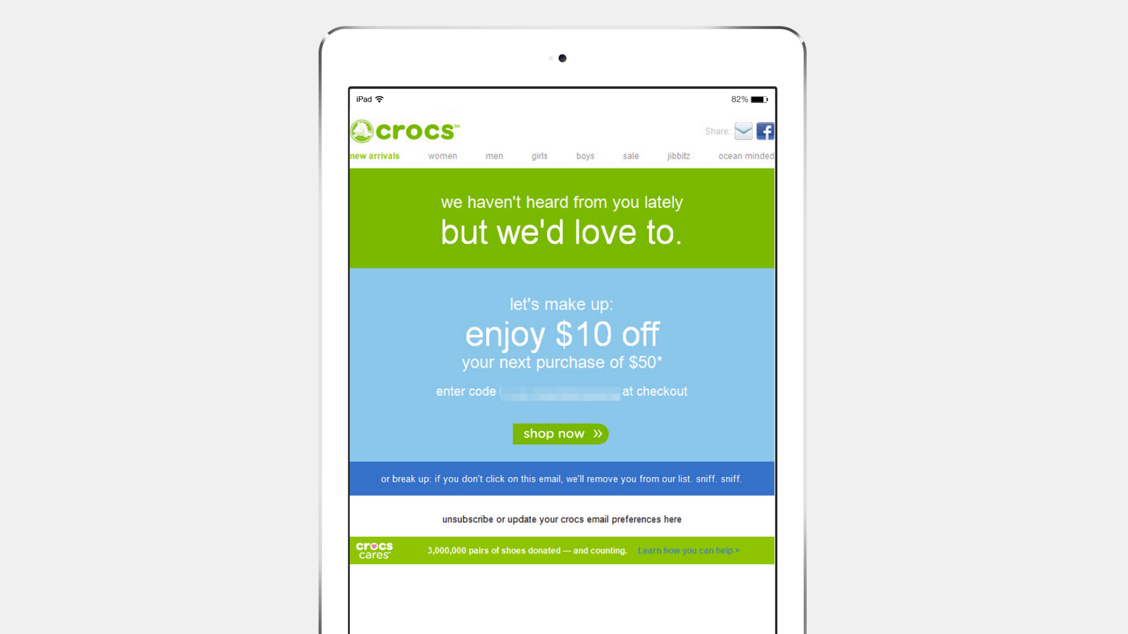 A tablet displaying a Crocs promotional webpage offering $10 off the next purchase of $50. The message invites users to enter a code at checkout.