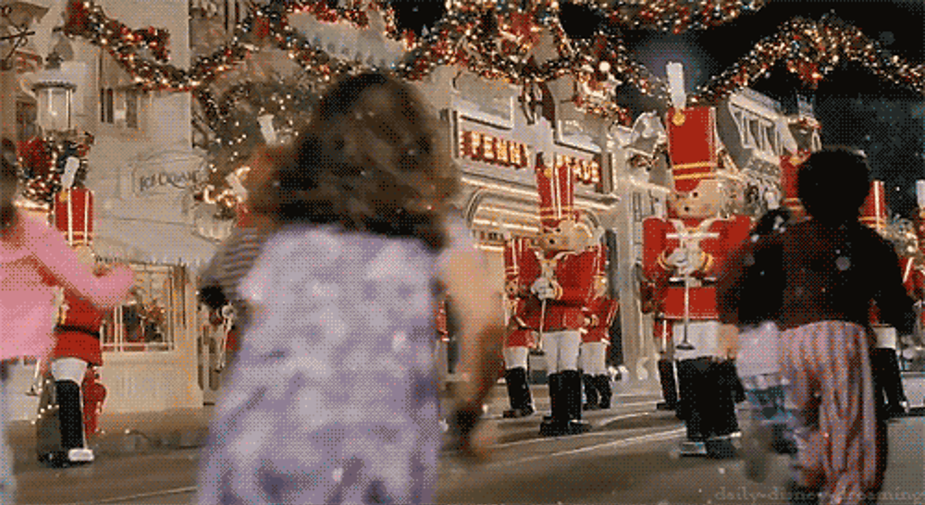 Children running towards a festive parade featuring toy soldiers and holiday decorations. The scene is lively and filled with excitement.