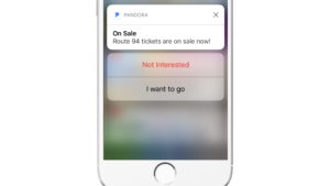 A smartphone screen displaying a notification from Pandora about Route 94 tickets being on sale, with options to respond.