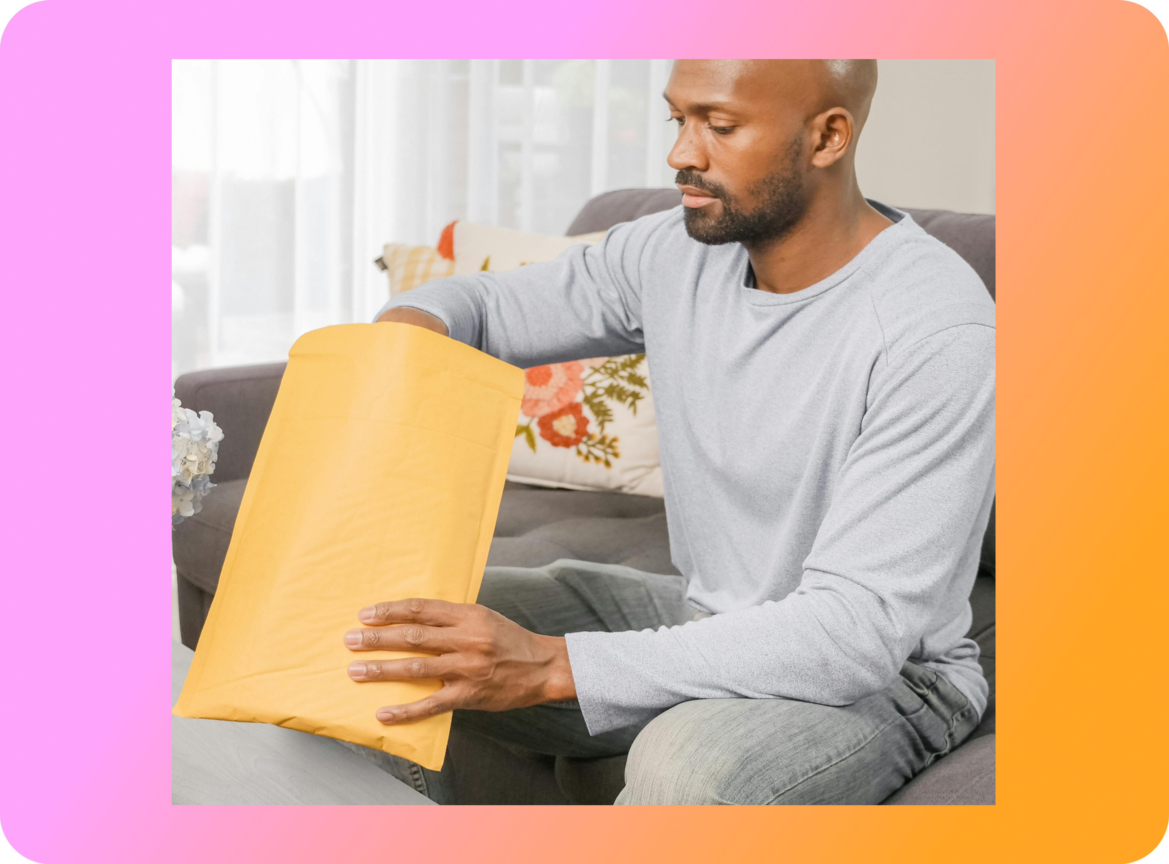 Man opening a large envelope.