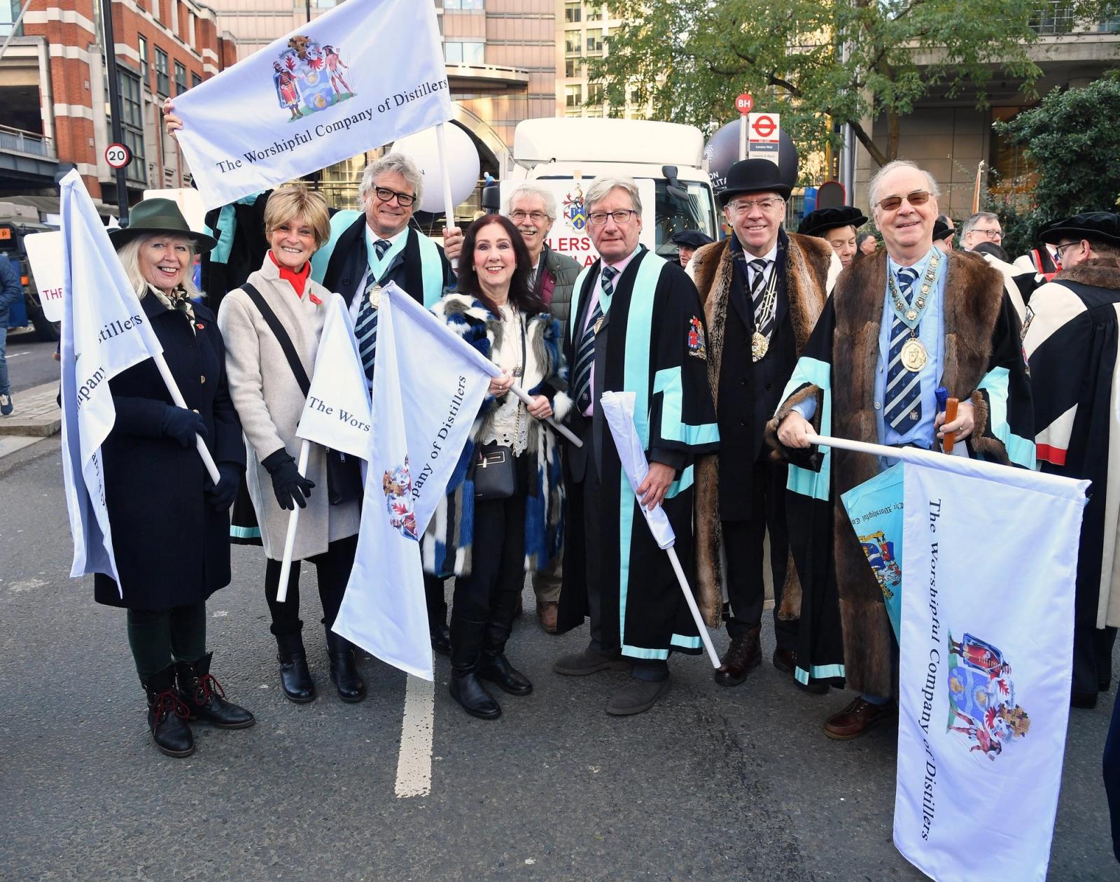 Distillers’ Company members in livery gowns carrying Company flags at the Lord Mayor’s Show.