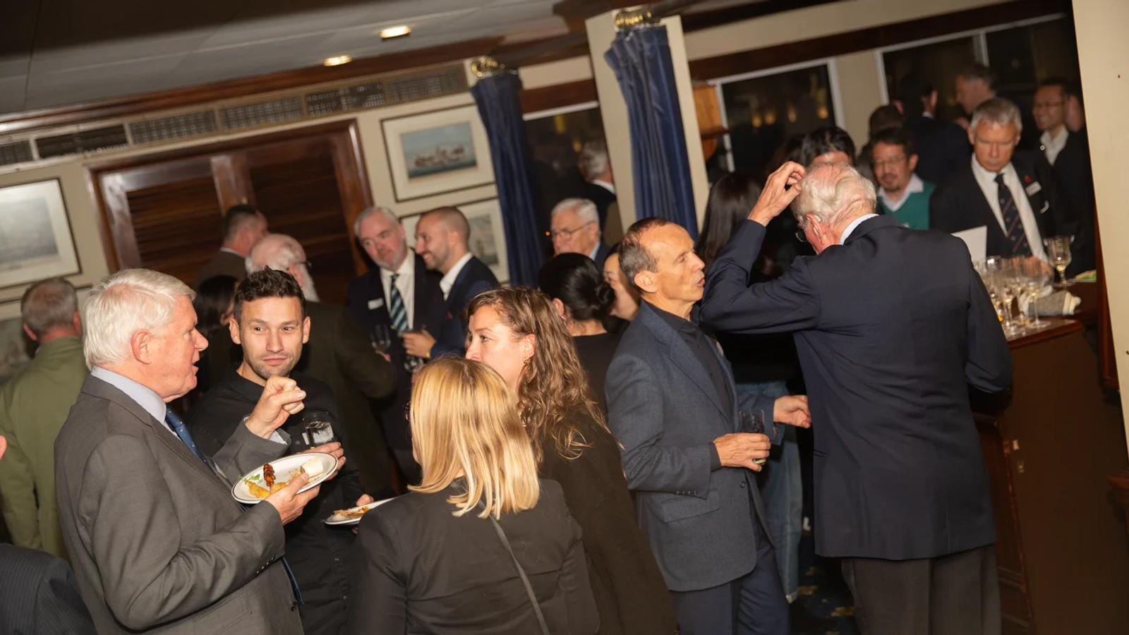 Members and guests talking over drinks at a Distillers social.