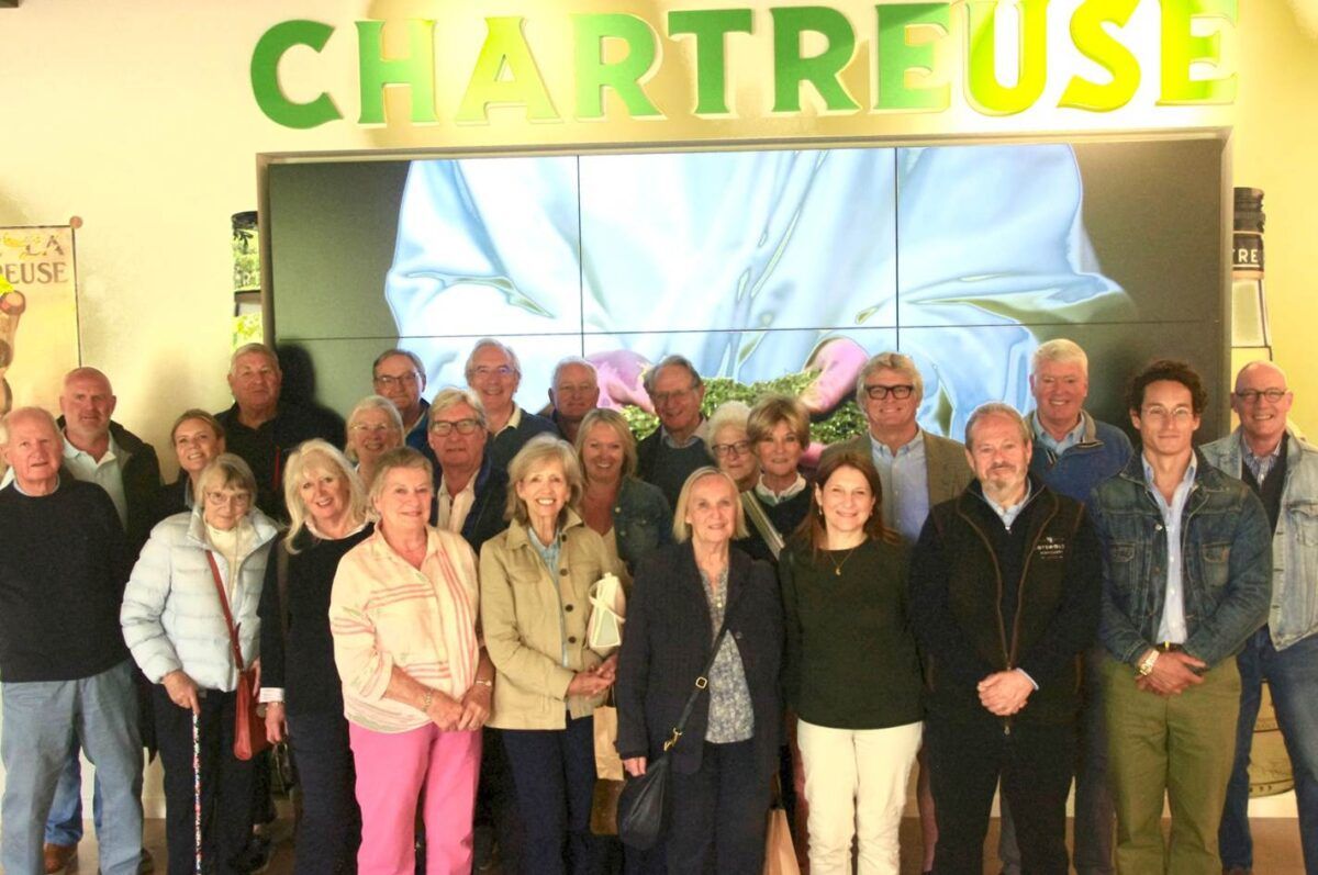 Members of the Livery Court standing in front of a Chartreuse sign