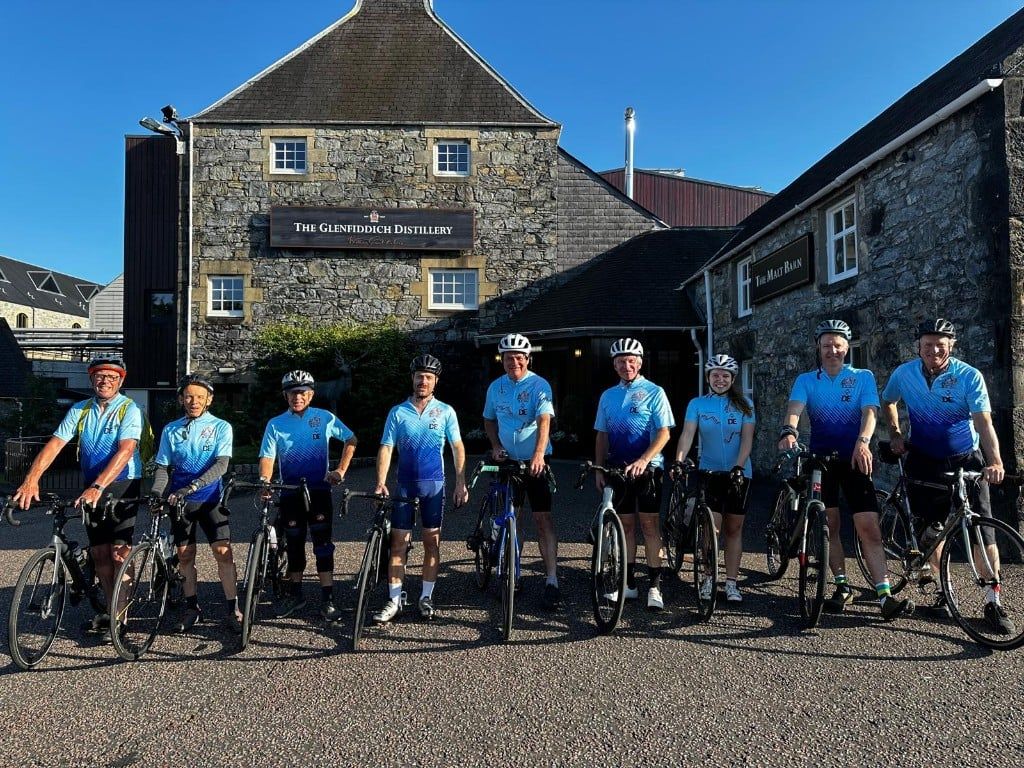 Distillers’ Velo Club riders in Company cycling jerseys with their bikes outside the Glenfiddich Distillery.