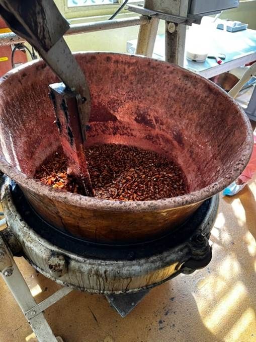 Praline being stirred in a copper bowl