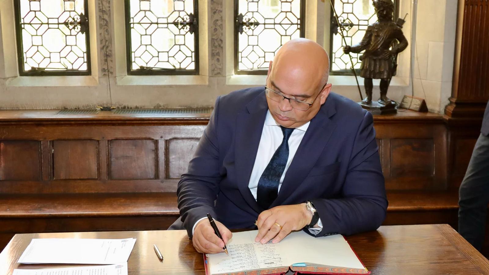 A Freeman signs the declaration book.