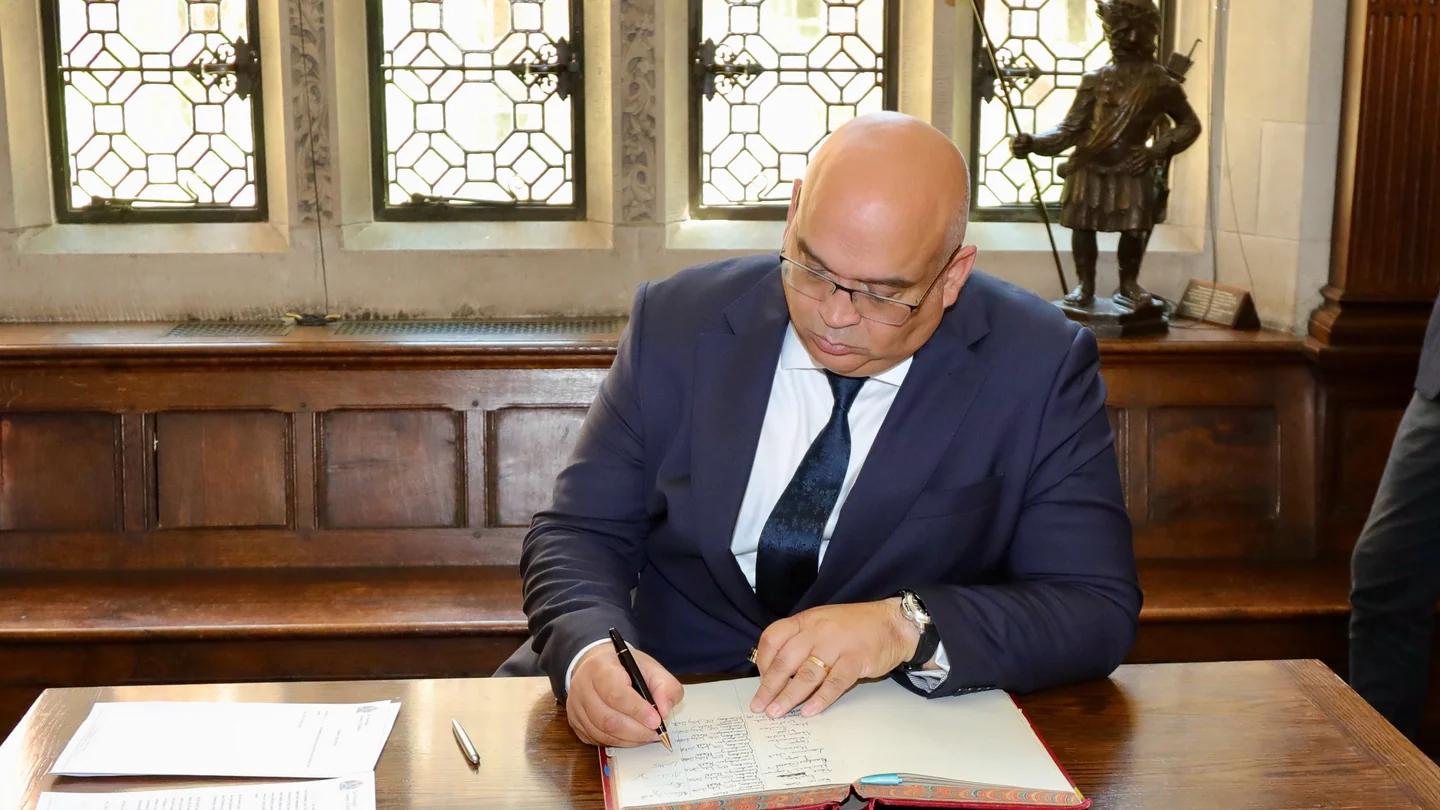 A Freeman signs the declaration book.