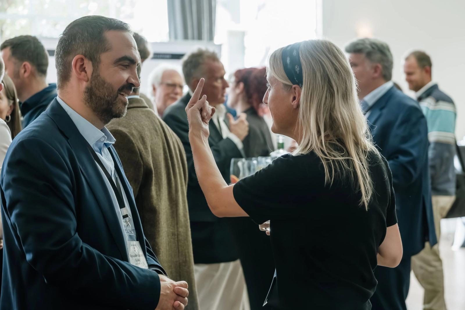 Delegates in conversation between sessions at Ginposium London 2026.