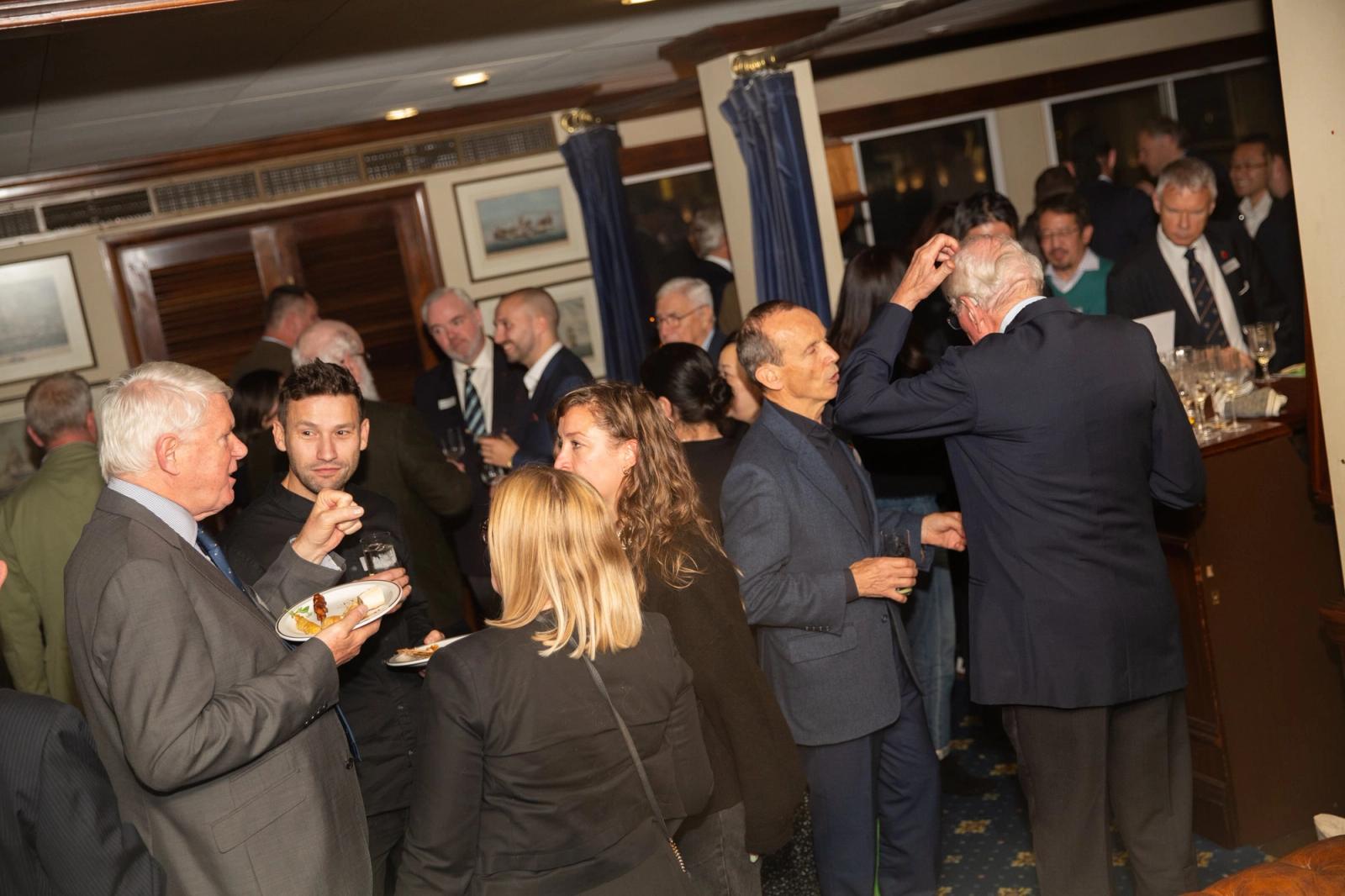 Members in conversation at an informal Company evening reception.
