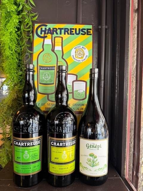 Three Chartreuse bottles and a bottle of Génépi