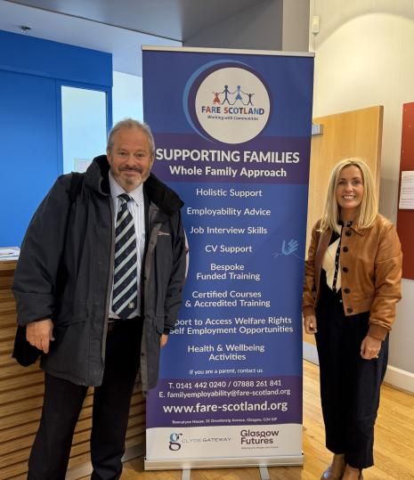 Daniel Szor with a colleague beside a FARE Scotland banner describing its whole family approach