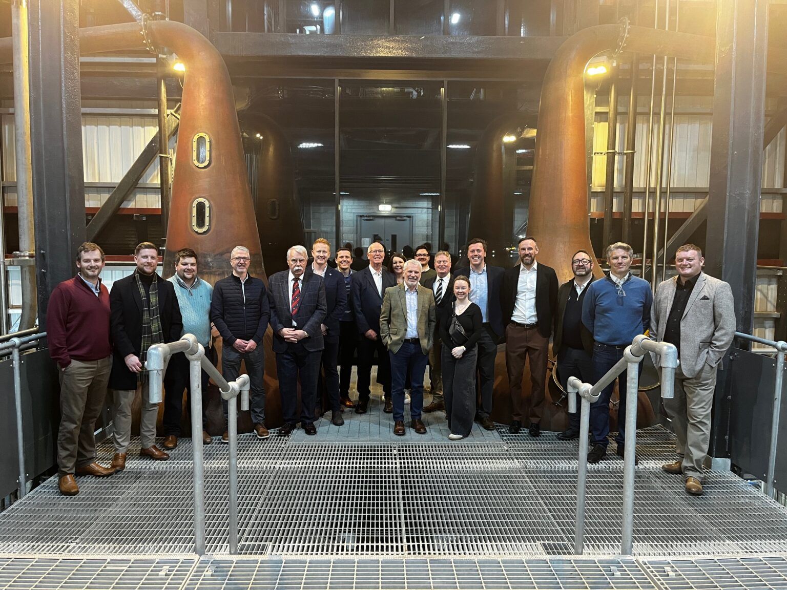 The group in front of copper pot stills
