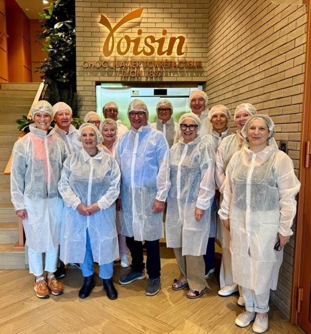 A group in hairnets outside Chocolats Voisin